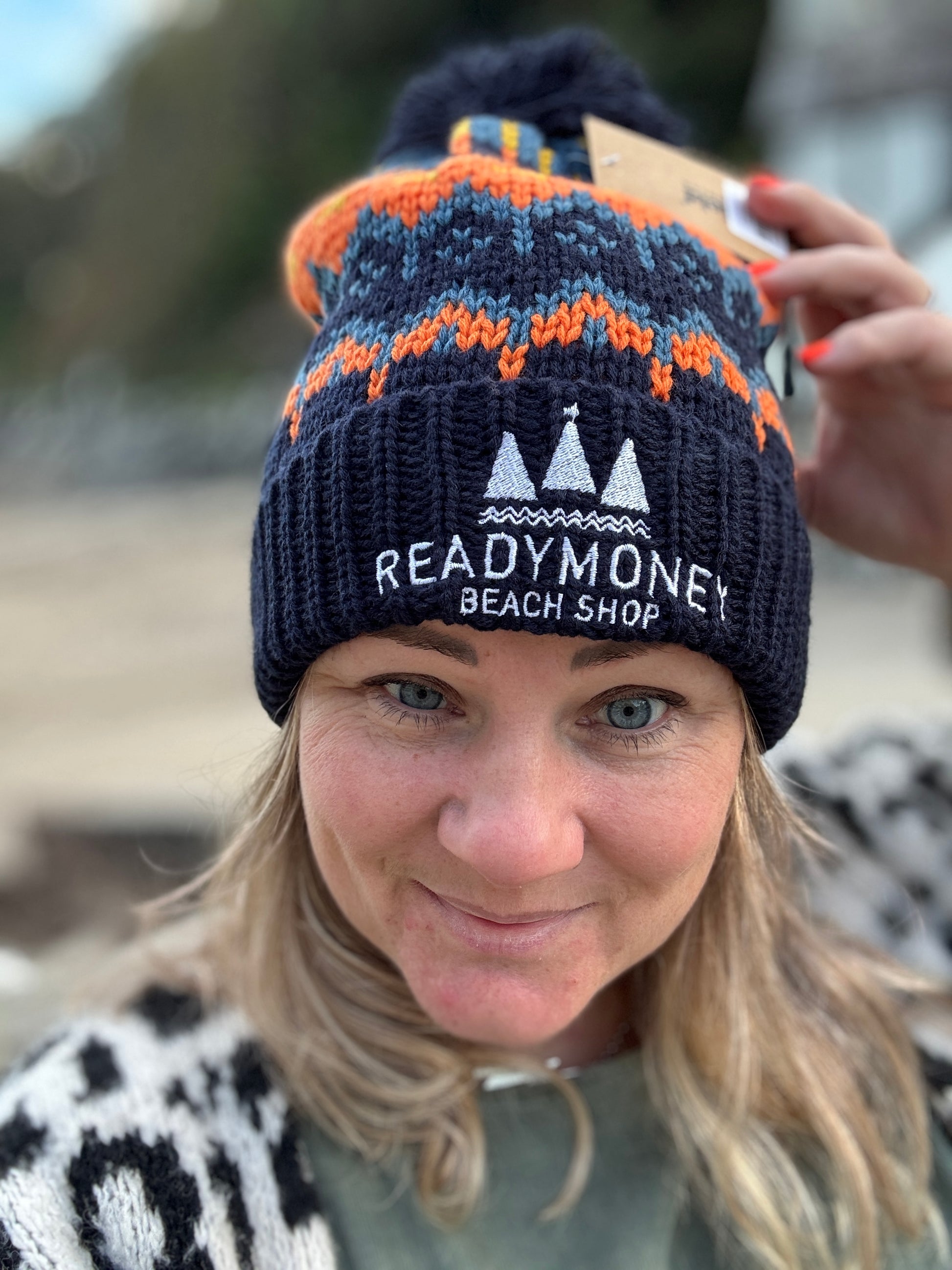 retro-style bobble hat with zigzag knit pattern and embroidered beach shop logo—warm, colorful winter accessory for coastal adventures