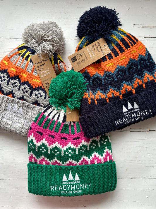 set of retro knit bobble hats with bold zigzag patterns, ribbed brims, and eco tags—colorful, recycled winter accessories