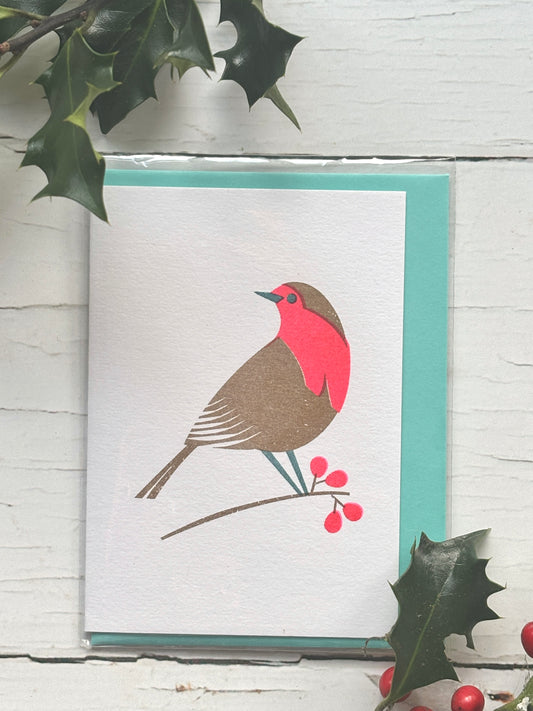 retro-style robin card—minimalist red-breasted bird on berry branch with holly, perfect for vintage Christmas decor and gifting