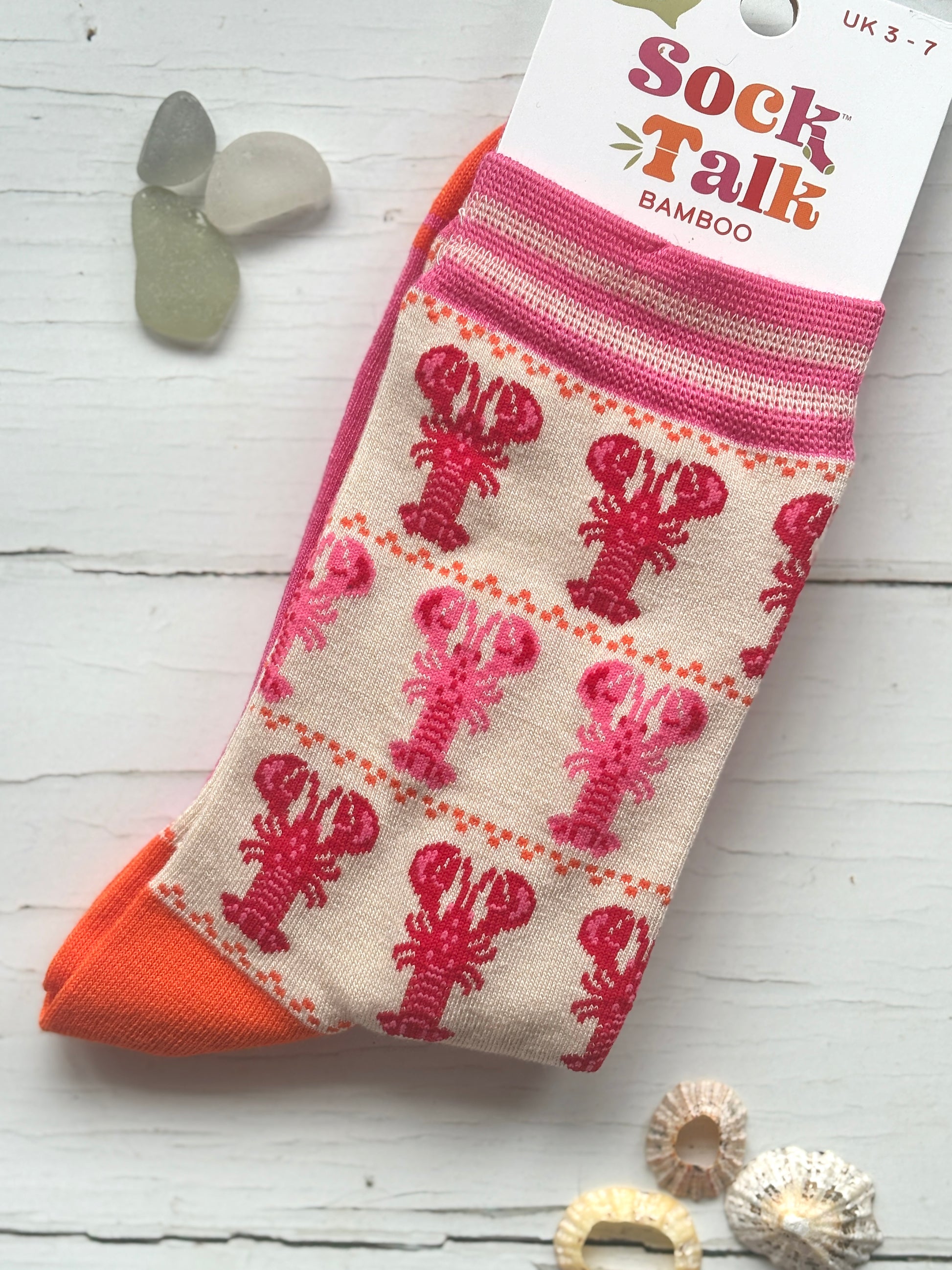 bamboo knit socks by Sock Talk featuring rows of pink and red lobsters bright orange accents make a unique coastal gift