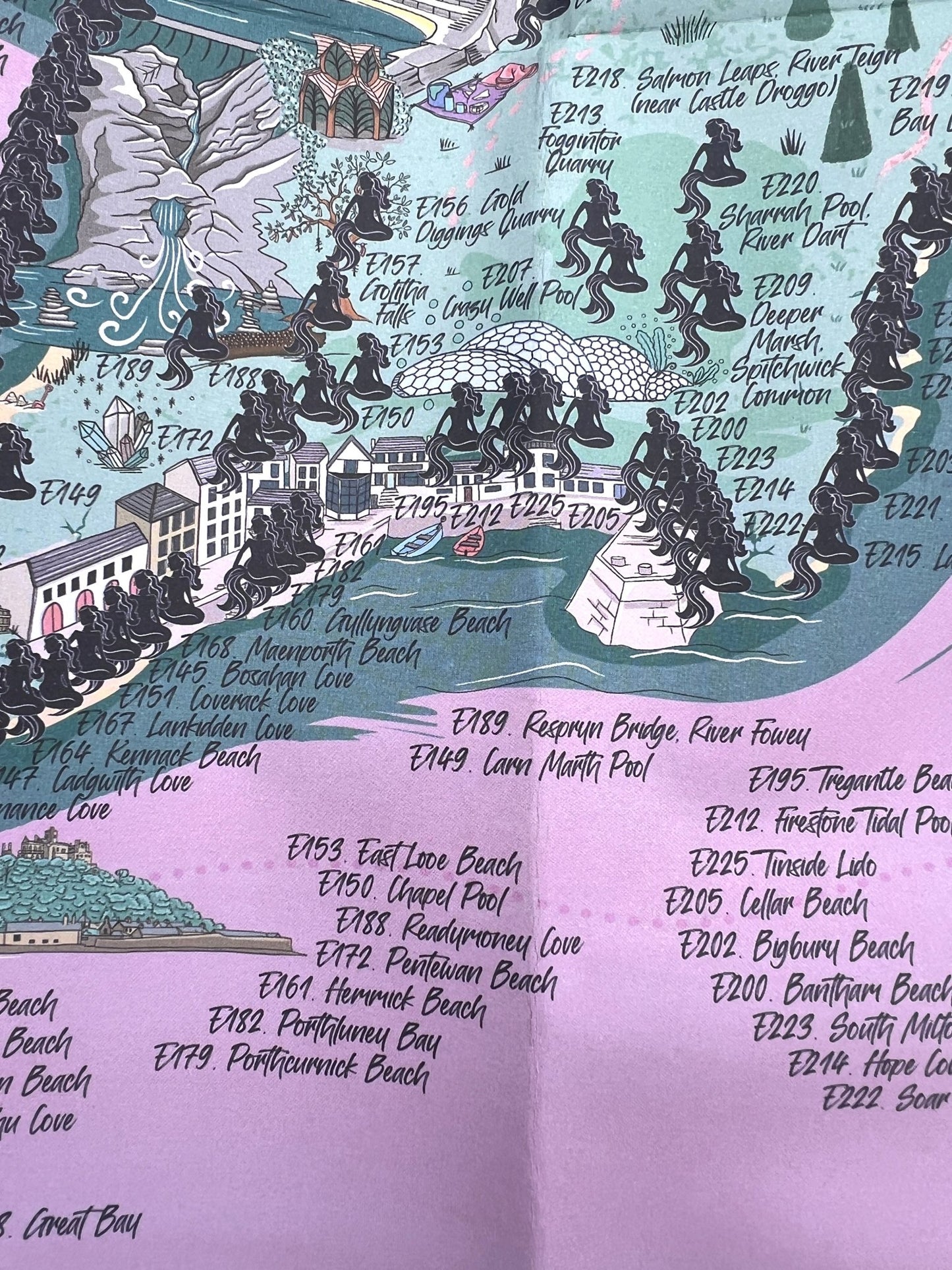 mermaid-themed England swim map poster with 300+ wild swim spots, coastal coves, and quarry illustrations