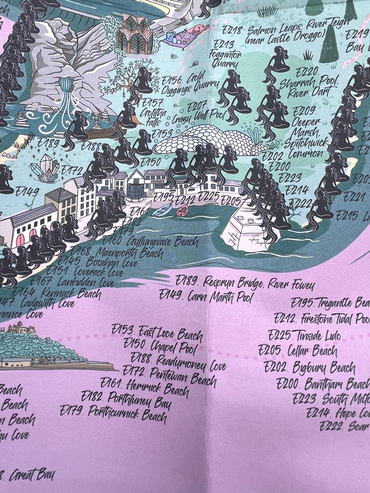 mermaid-themed England swim map poster with 300+ wild swim spots, coastal coves, and quarry illustrations
