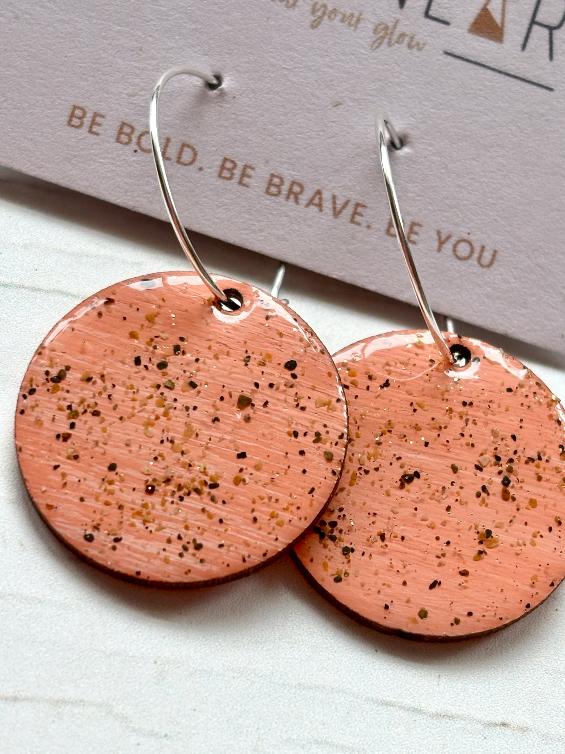 pink sterling silver hoop earrings close-up handmade resin with sand texture boho-chic, modern coastal fashion jewelry