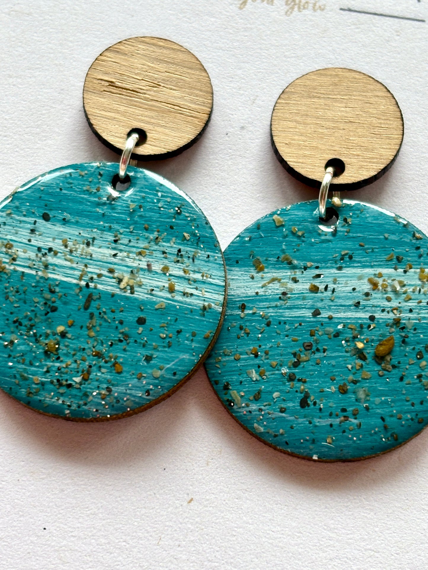 teal stud earrings with wood top. sterling silver hooks and sand-speckled resin coastal, handmade dangle jewelry