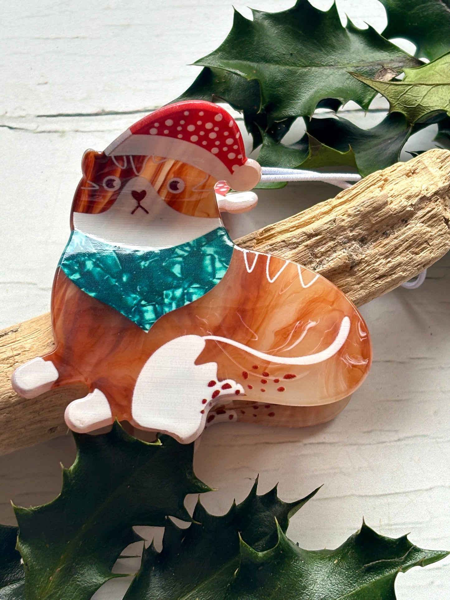ginger tortoiseshell cat hair claw Christmas clip with a Santa hat and teal glitter scarf unique holiday feline accessory
