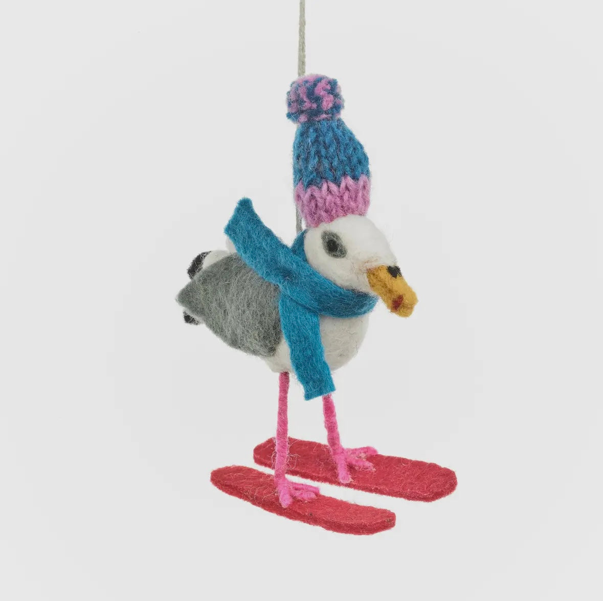front view of felt seagull ornament with skis, knit hat, and scarf—quirky coastal Christmas tree decoration