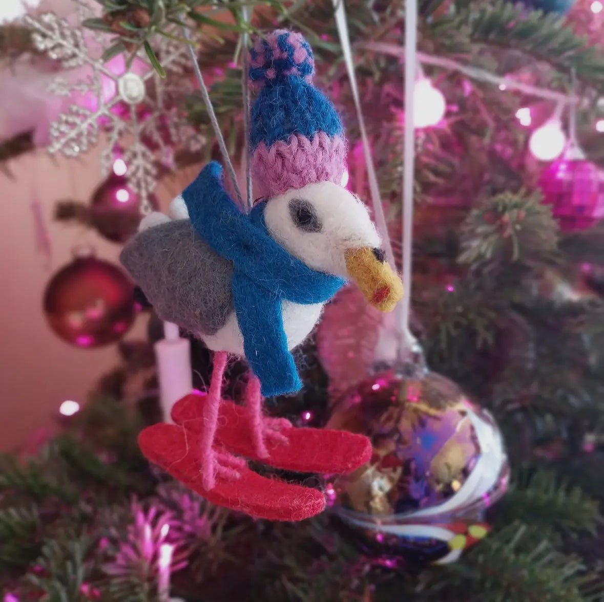 felt seagull Christmas ornament with skis, knit hat, and scarf—coastal holiday tree decor with festive charm