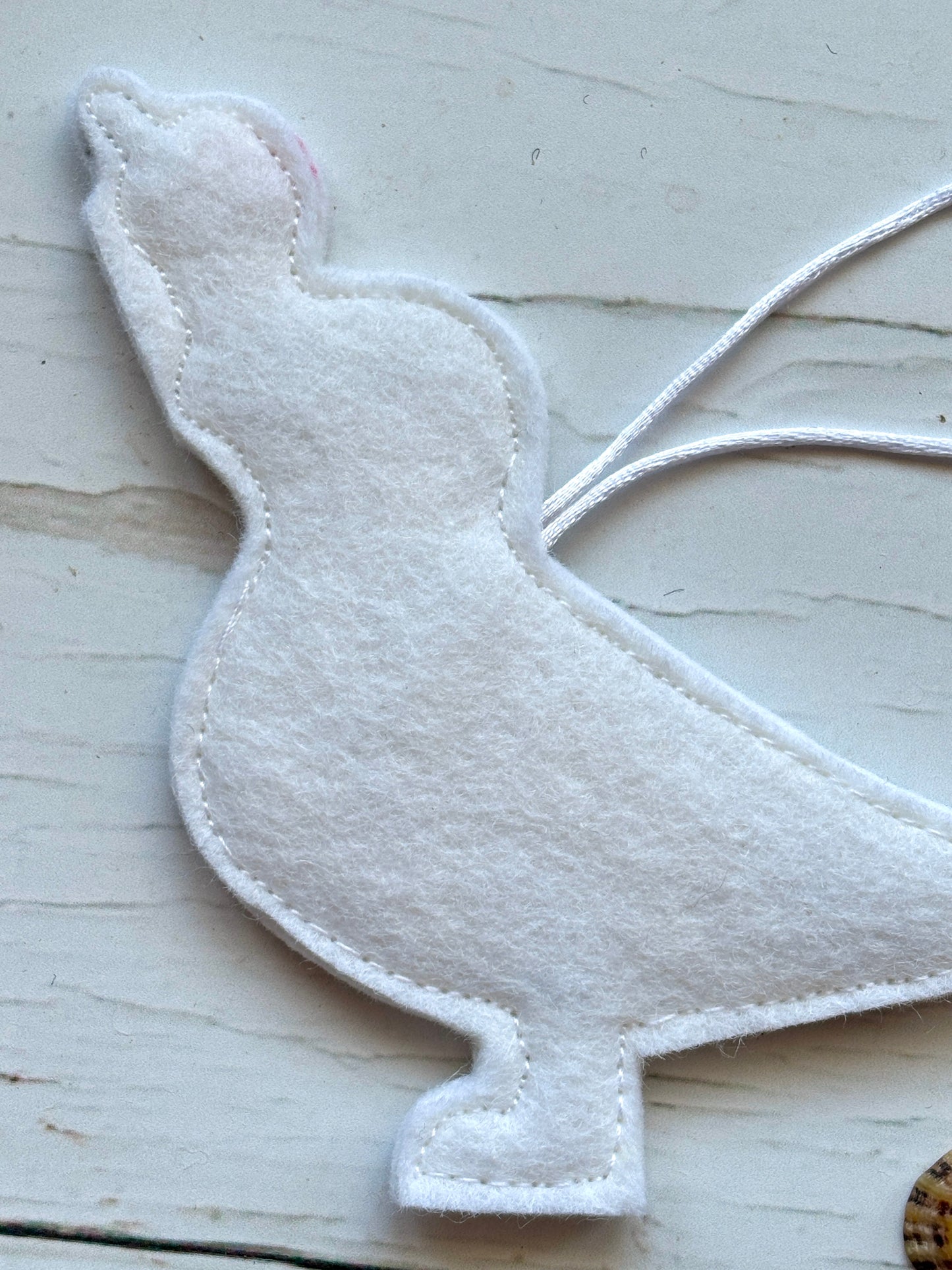 back view of felt seagull hanging decor—hand-stitched coastal ornament with ice cream detail for summer styling