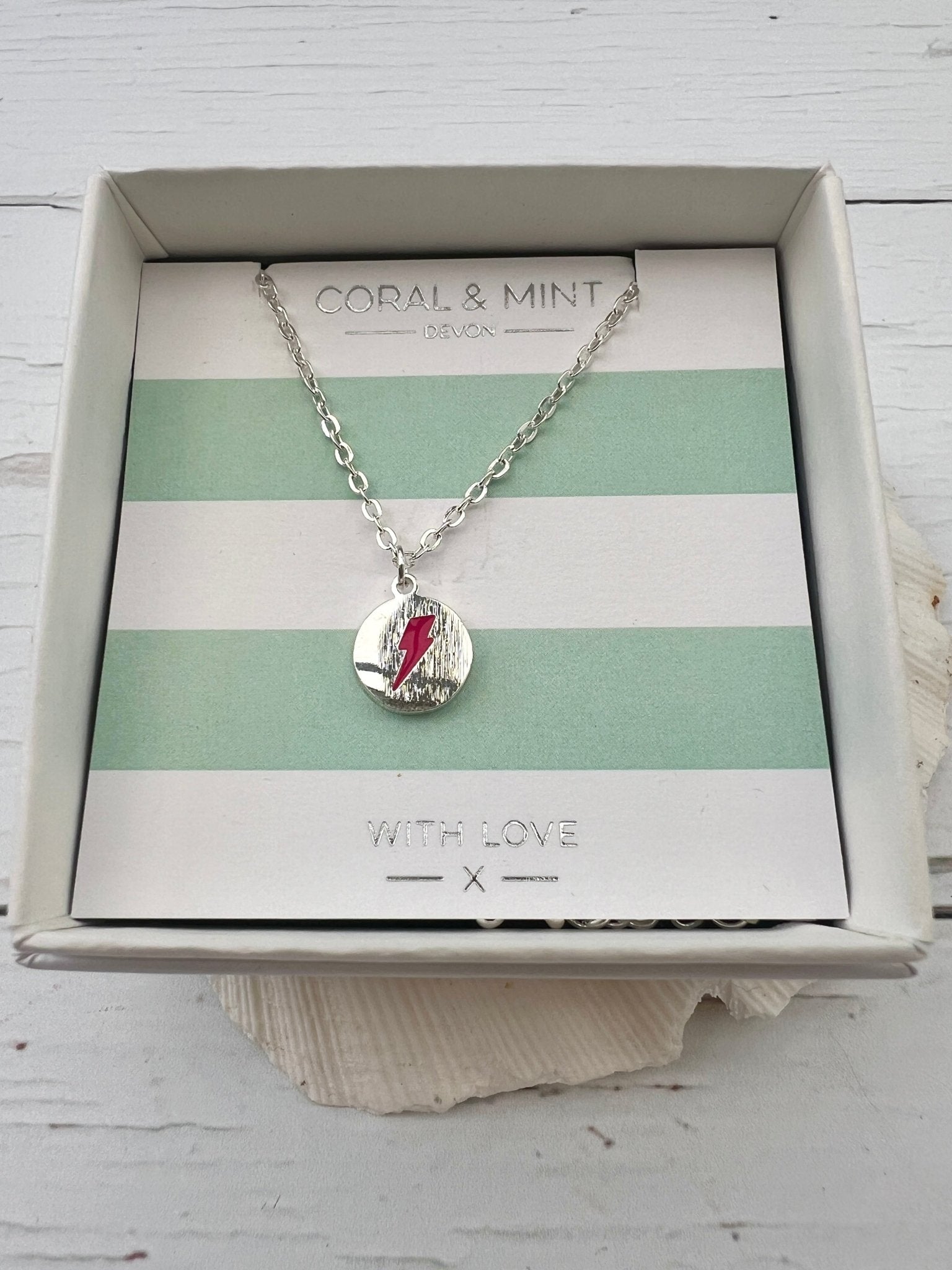 red enamel lightning bolt charm necklace by Coral & Mint silver dainty pendant on a striped gift card unique gift idea