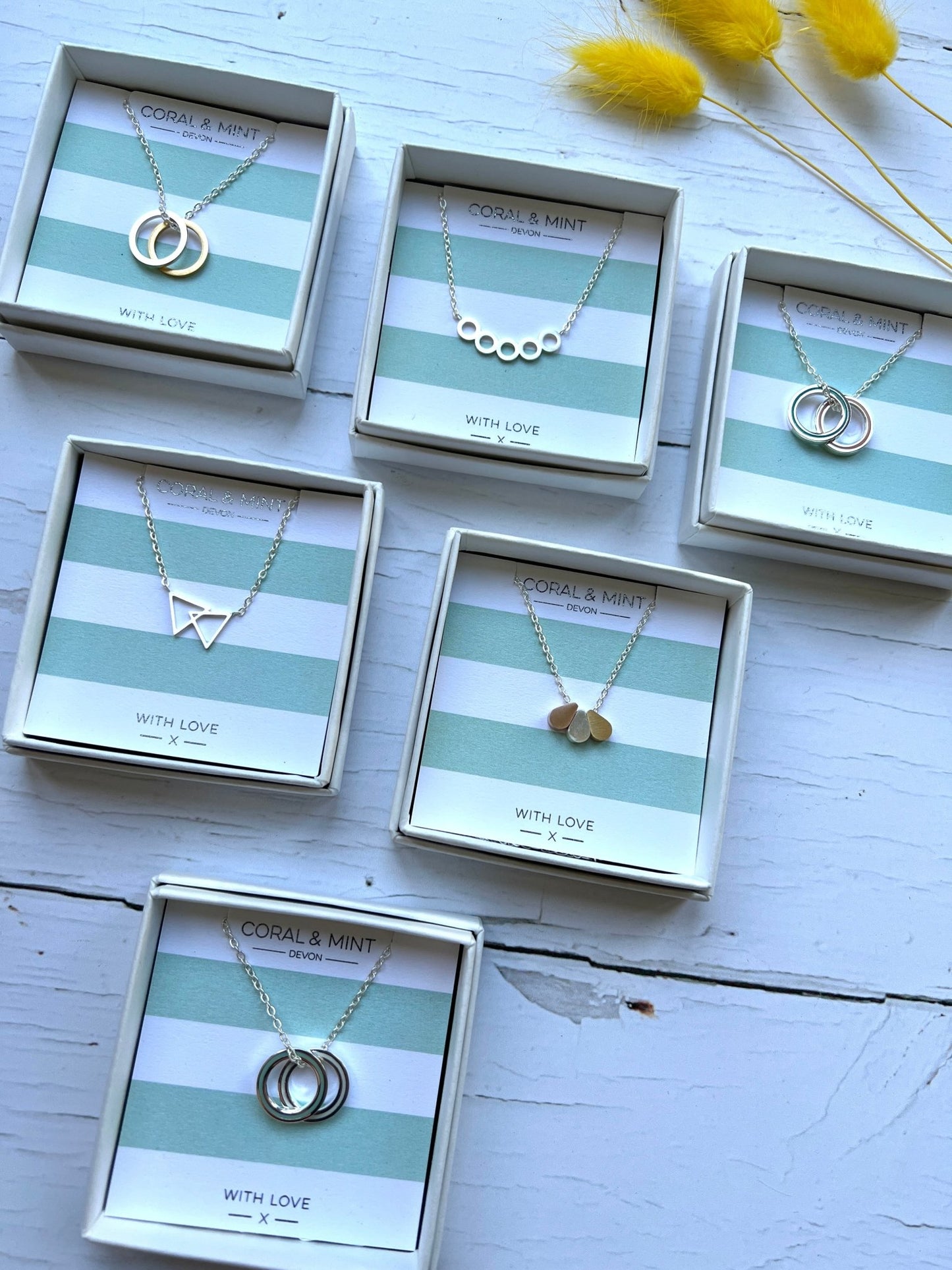 minimalist geometric pendant necklaces by Coral & Mint on striped gift cards elegant silver & gold jewelry