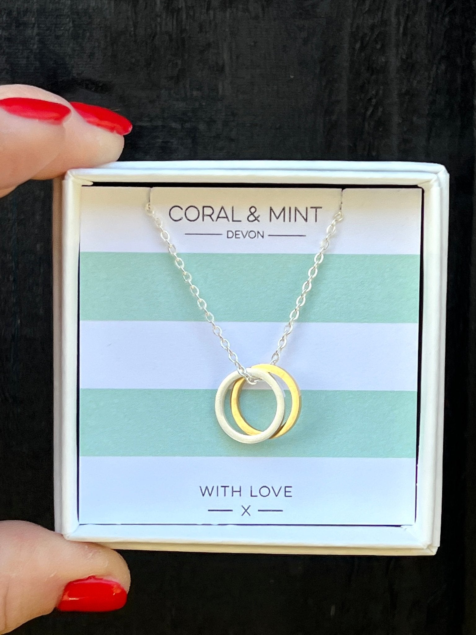mixed metal interlocking ring necklace in gold & silver. Minimalist geometric jewelry by Coral & Mint