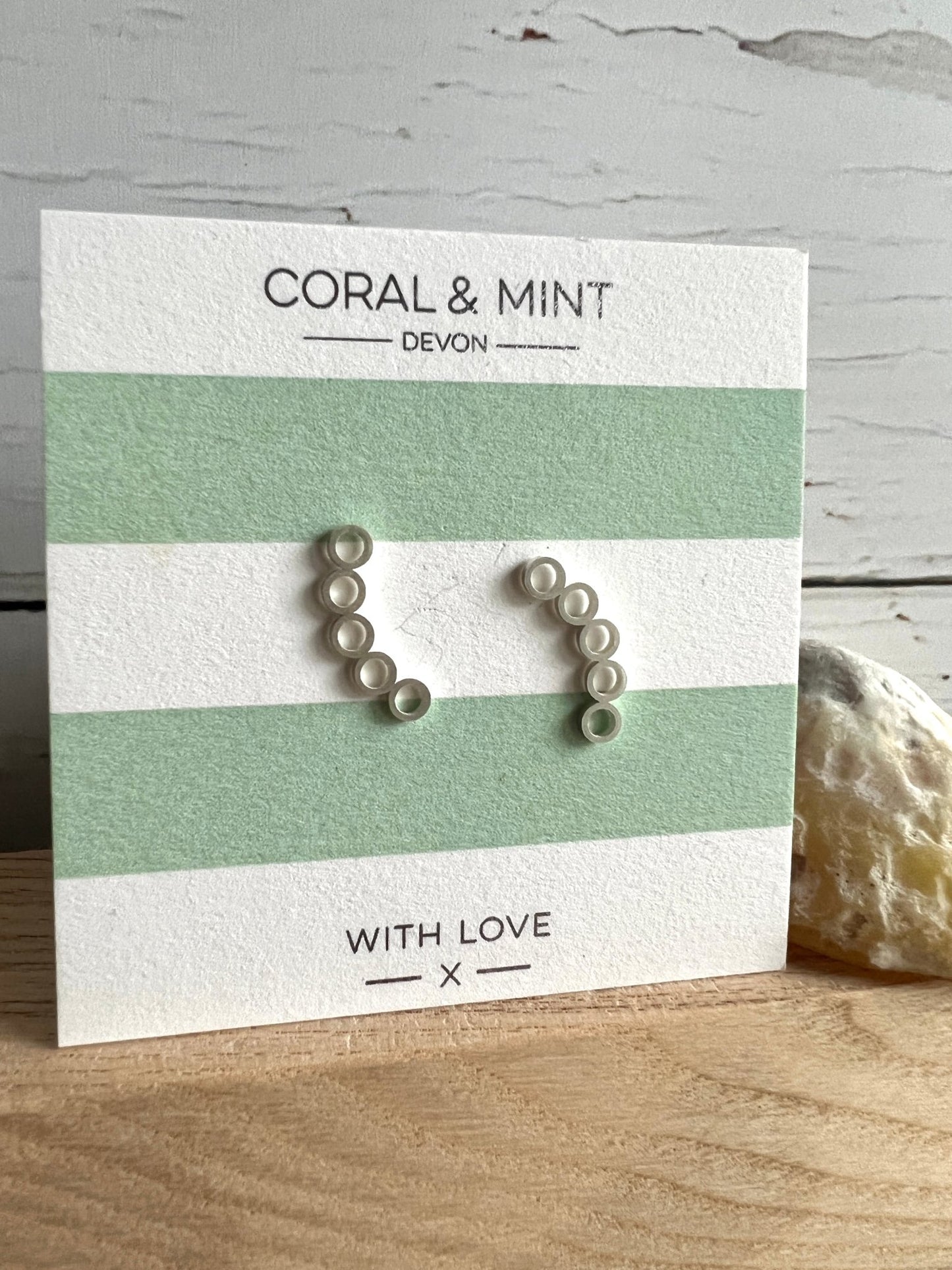silver bubble circle crawler earrings by Coral & Mint minimalist geometric jewelry on a striped gift card chic gift idea