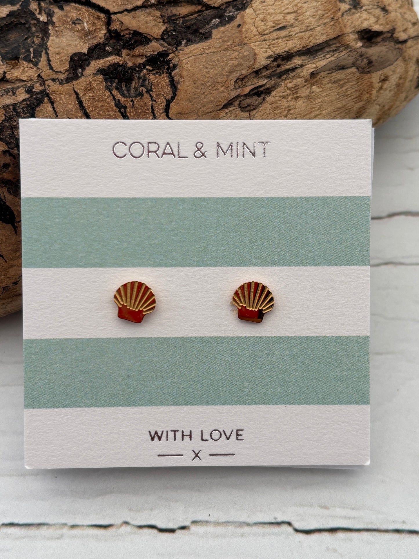 gold shell stud earrings by Coral & Mint dainty gold nautical jewelry on a striped gift card beachy summer gift idea