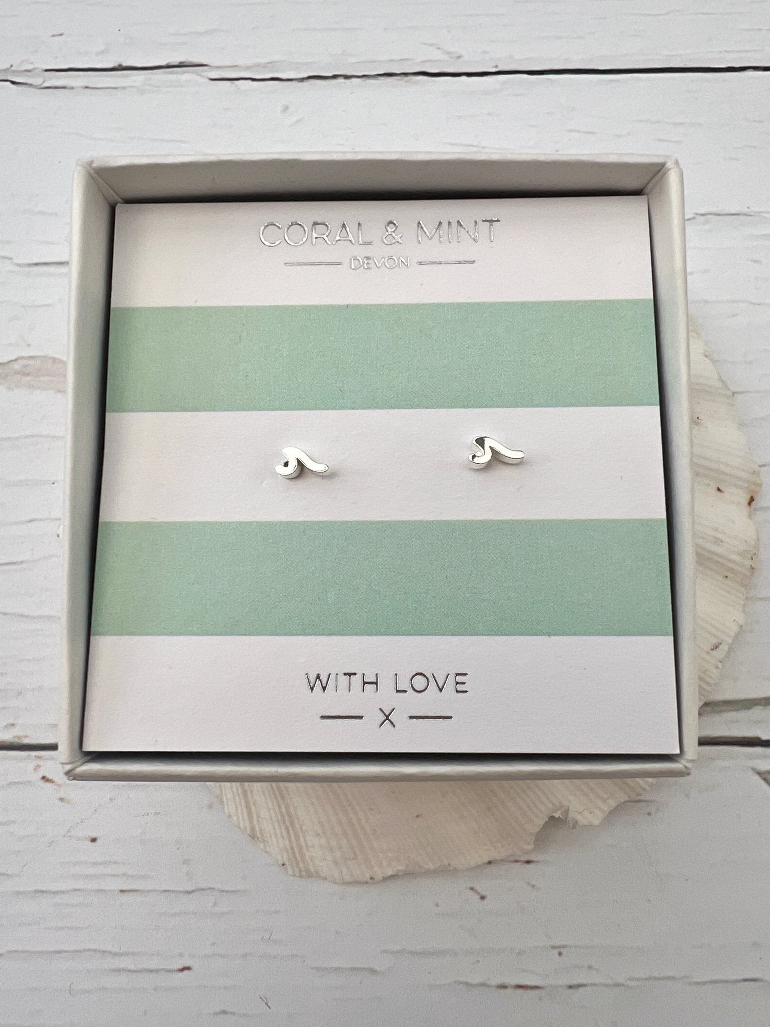 silver mini wave stud earrings by Coral & Mint dainty coastal jewelry on a striped gift card minimalist surf gift idea