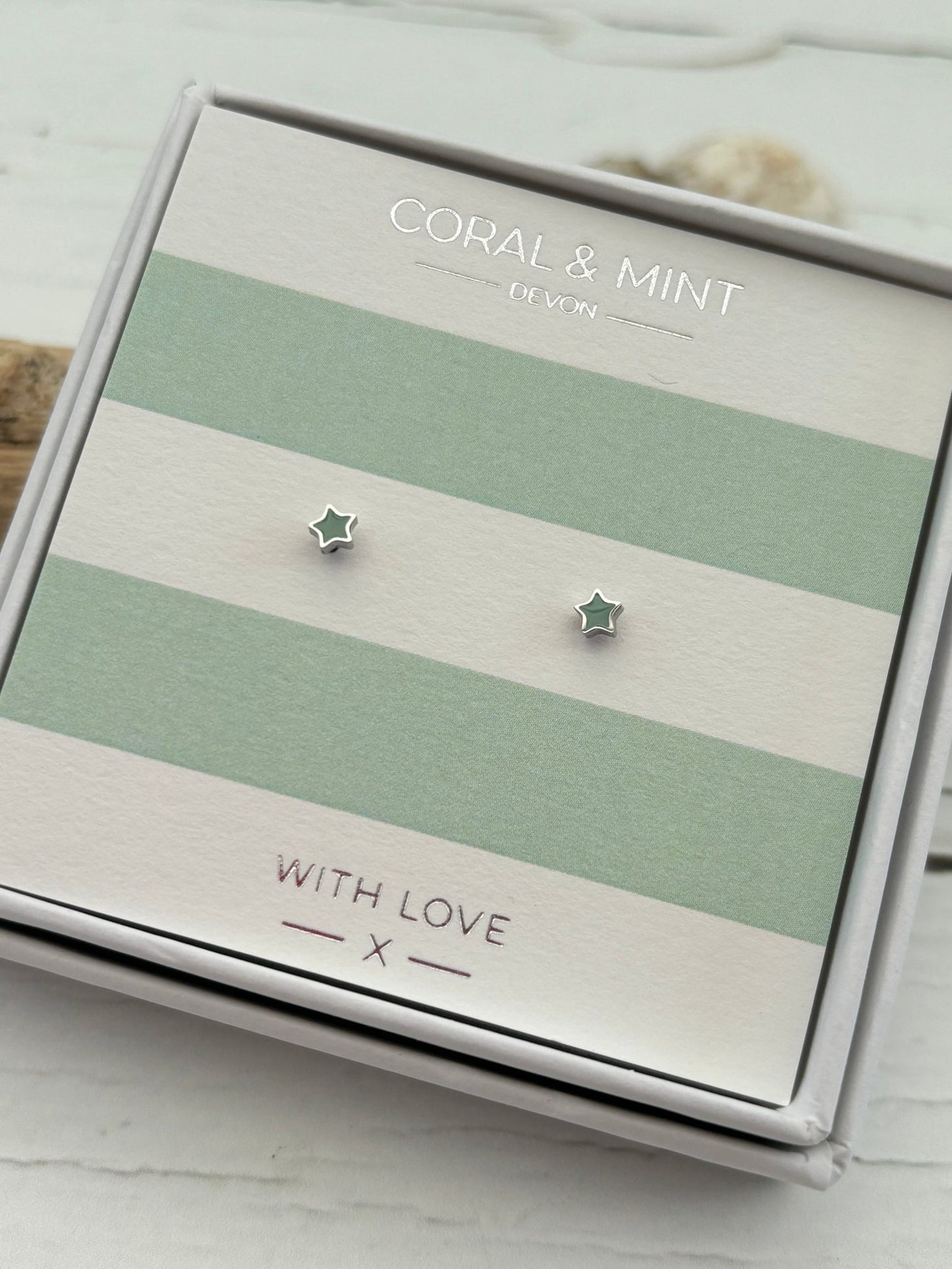 mini mint enamel star stud earrings by Coral & Mint dainty silver celestial jewelry on a striped gift card sweet gift