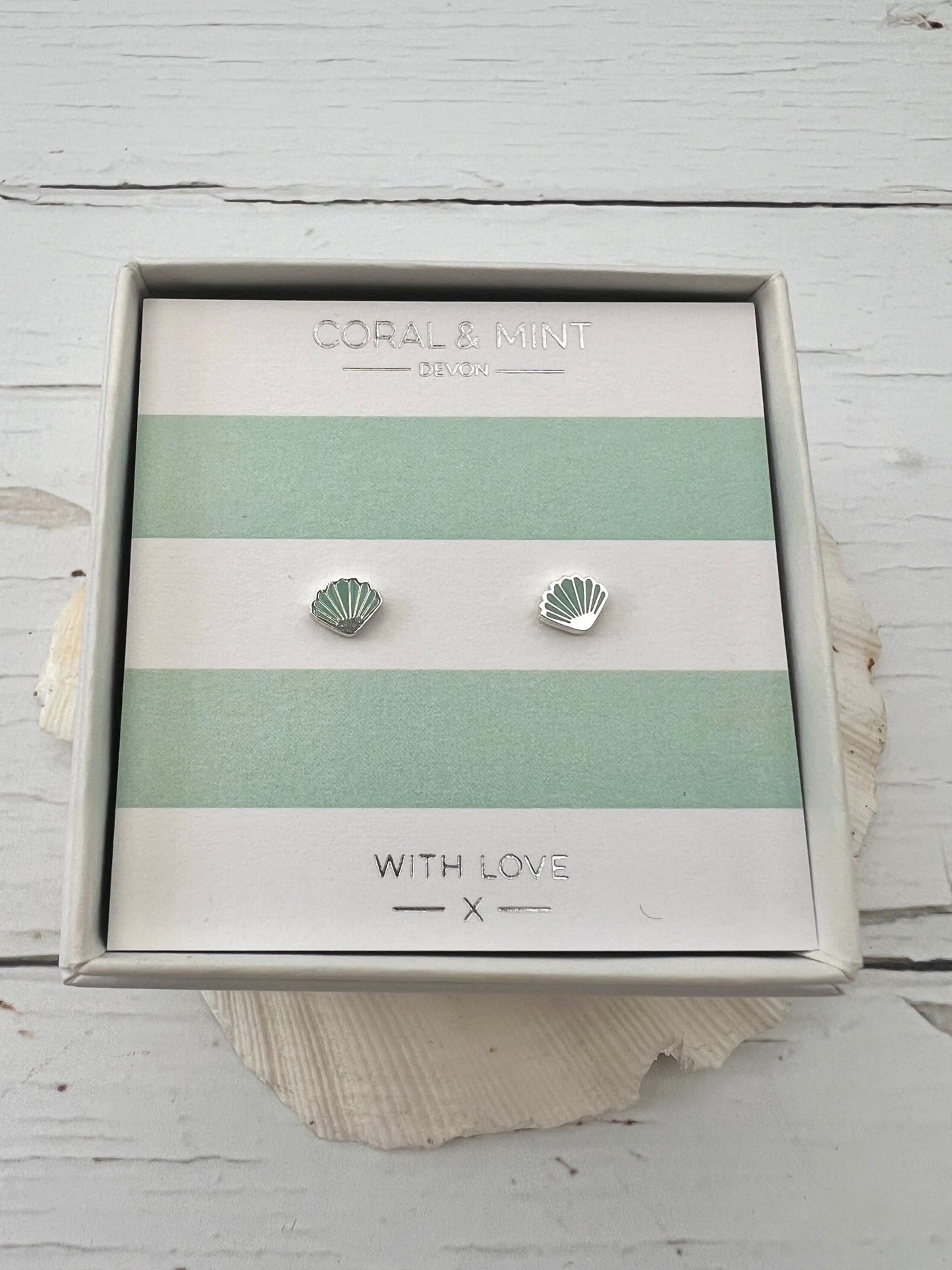 mint green enamel shell stud earrings by Coral & Mint dainty silver nautical jewelry on a striped gift card beachy gift