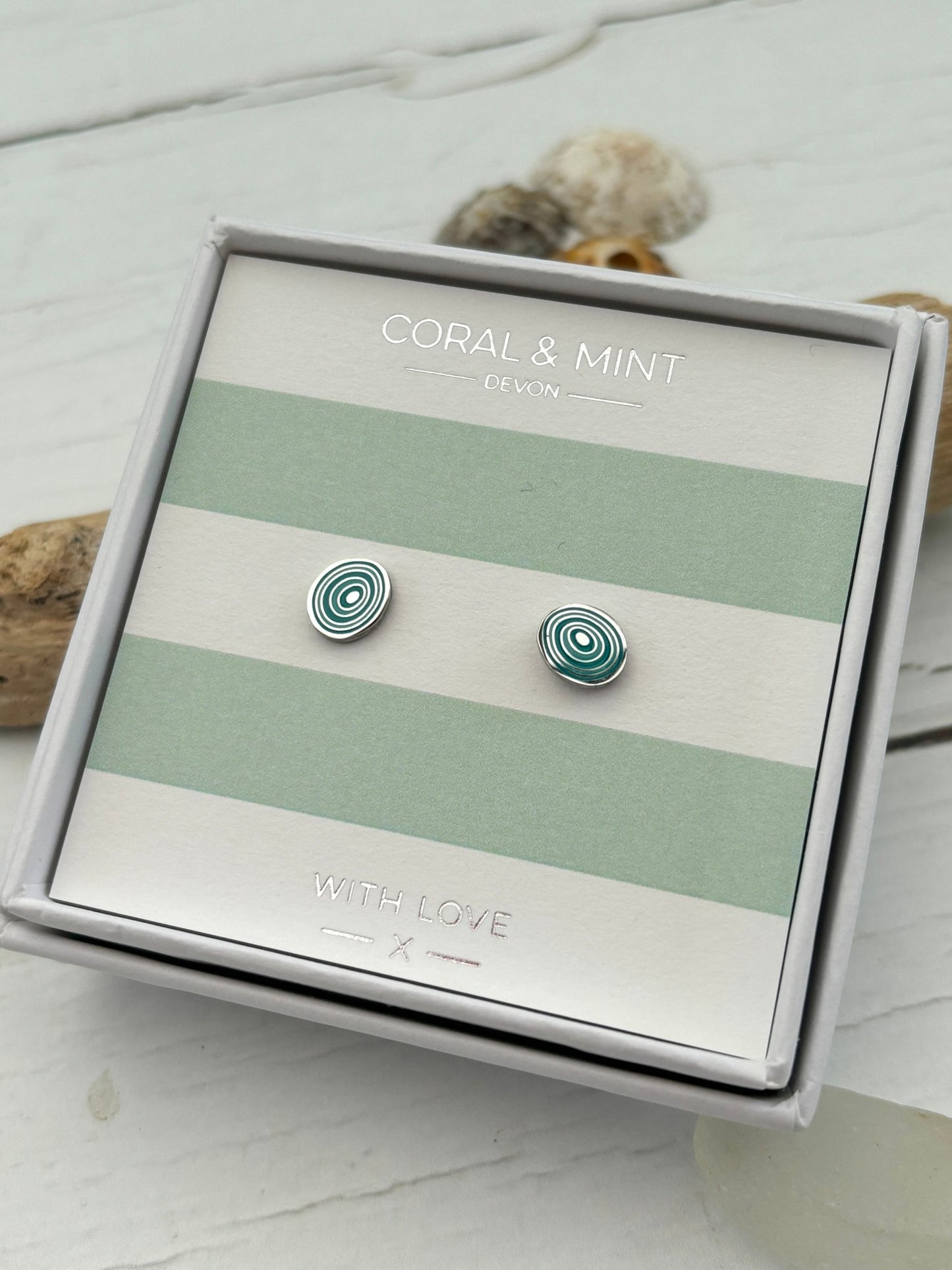 mint green enamel swirl stud earrings by Coral & Mint dainty silver jewelry on a striped gift card unique gift idea