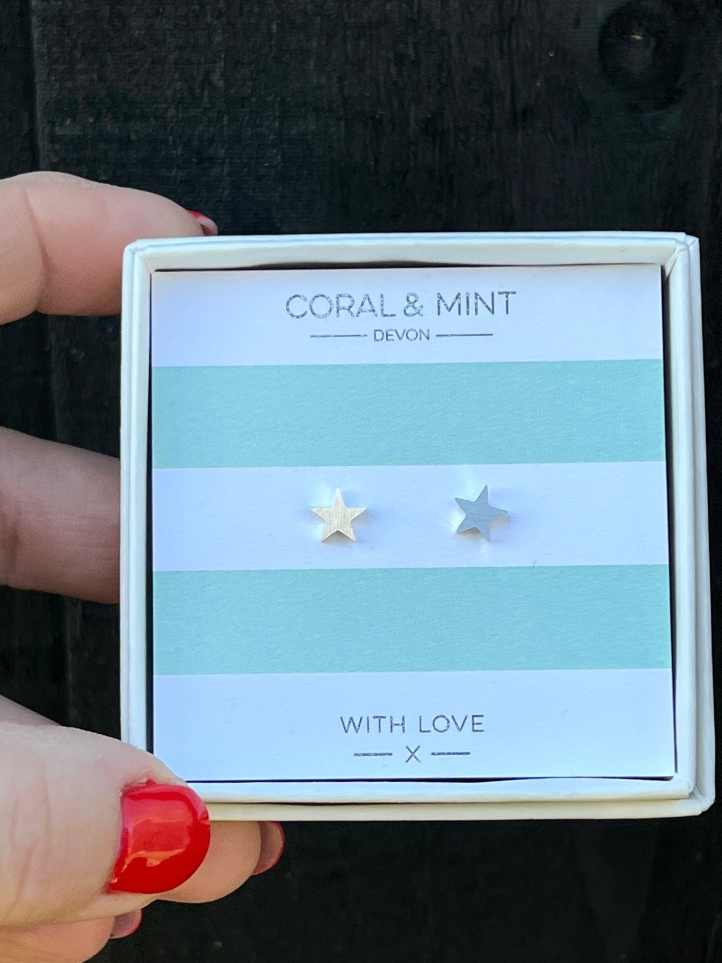 silver star stud earrings by Coral & Mint minimalist celestial jewelry on a striped gift card dainty gift idea