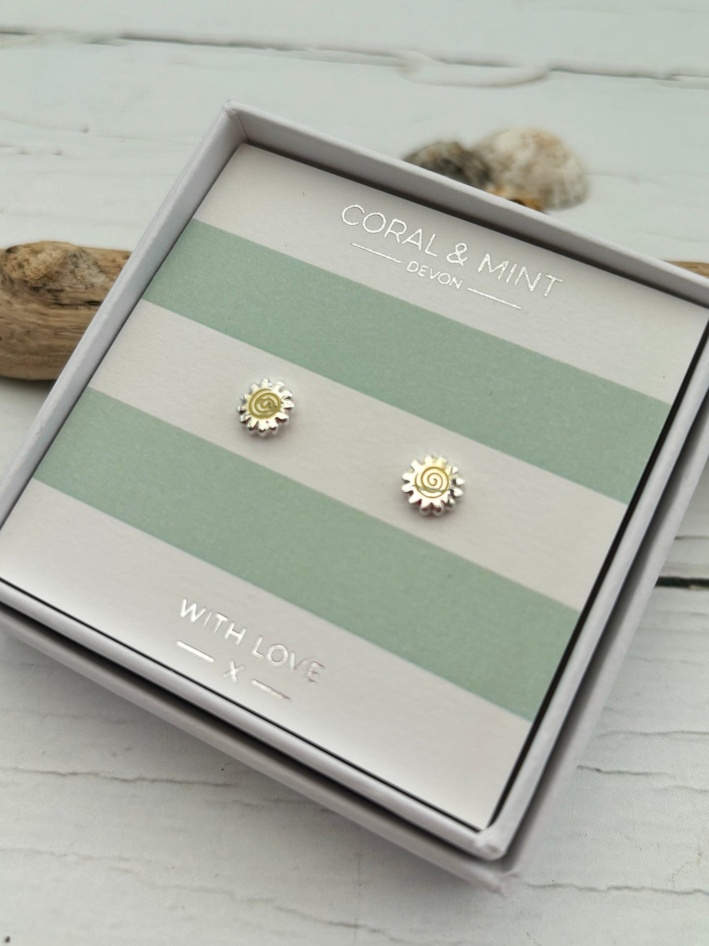 silver sunshine stud earrings by Coral & Mint dainty celestial jewelry on a striped gift card radiant summer gift idea