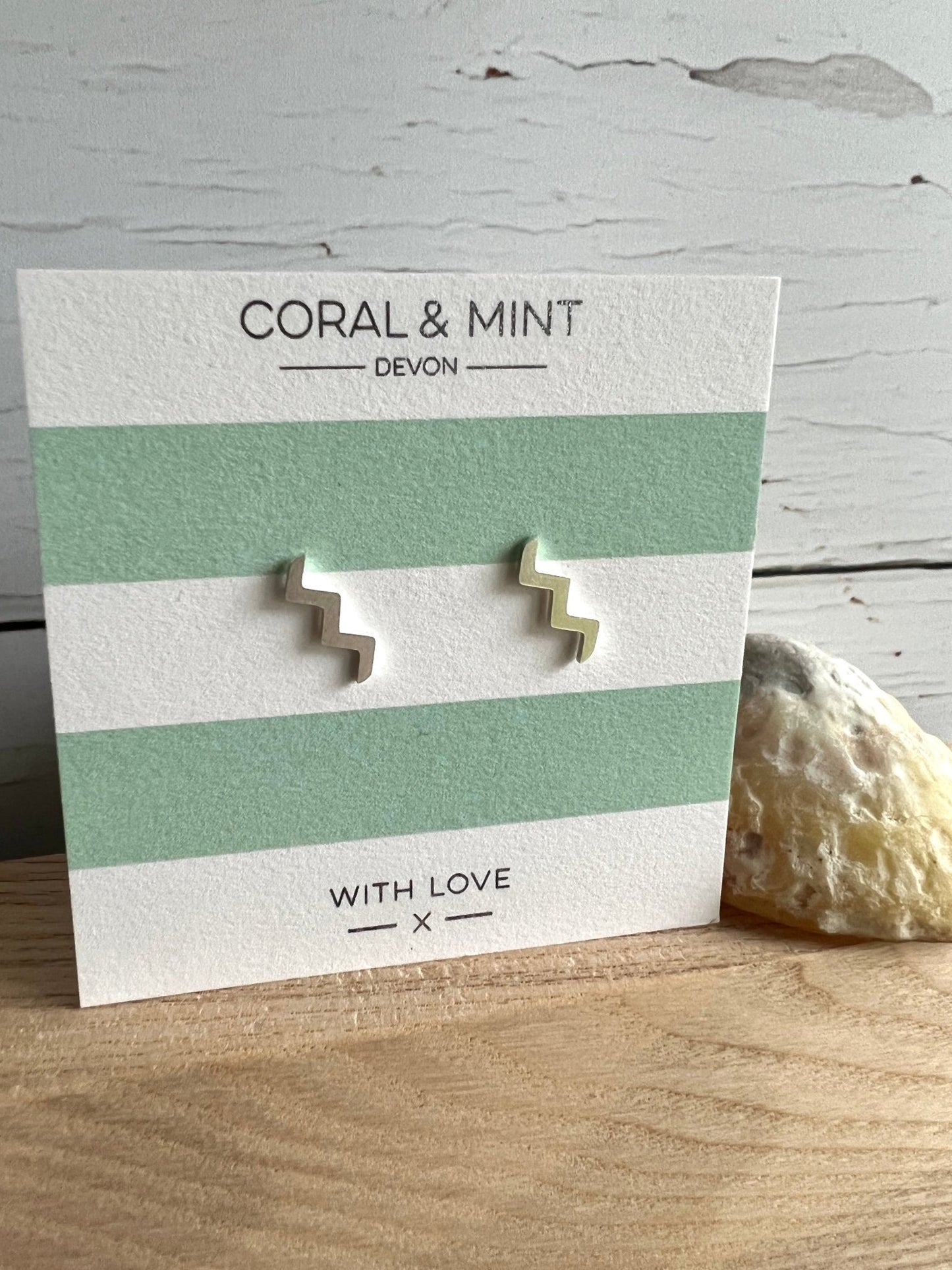 silver wave zig-zag stud earrings by Coral & Mint minimalist geometric jewelry on striped gift card unique gift idea