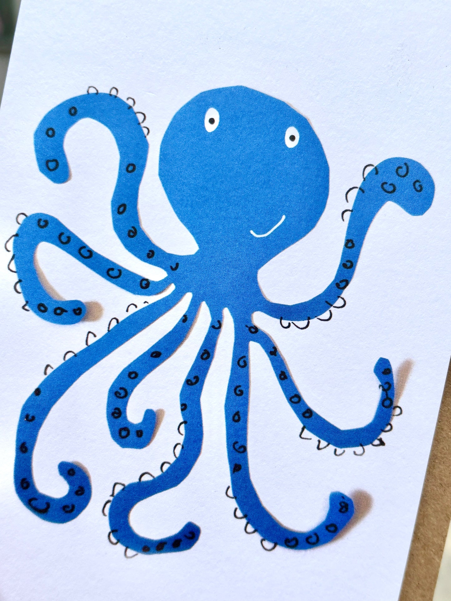 closeup shot of smiley blue octopus greeting card cute nautical stationery for any occasion coastal ocean-themed gift card