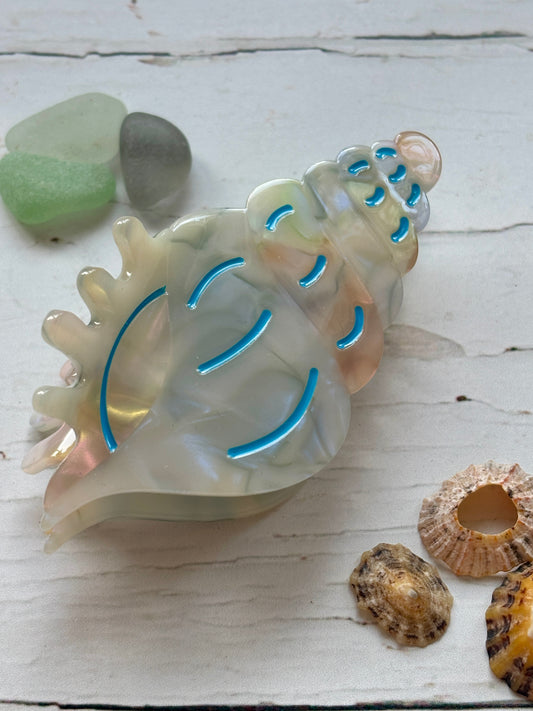 translucent spiral shell hair claw with ocean-blue accents—coastal-inspired clip for beachy summer hairstyles