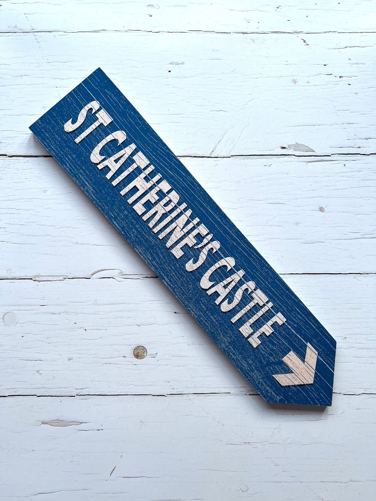 rustic blue wooden sign with white arrow—St Catherine’s Castle directional decor for coastal or heritage-themed styling