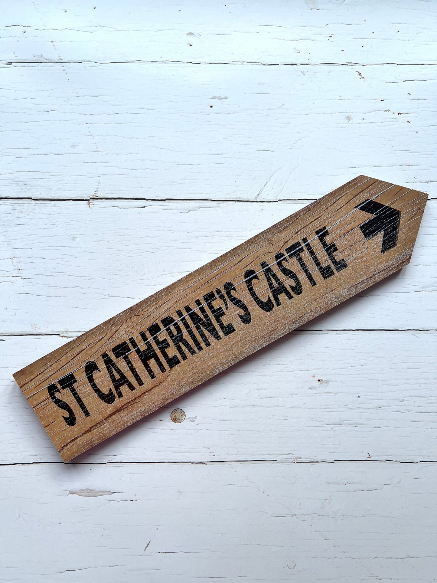 natural wood arrow sign with bold black text—St Catherine’s Castle directional decor for rustic coastal styling
