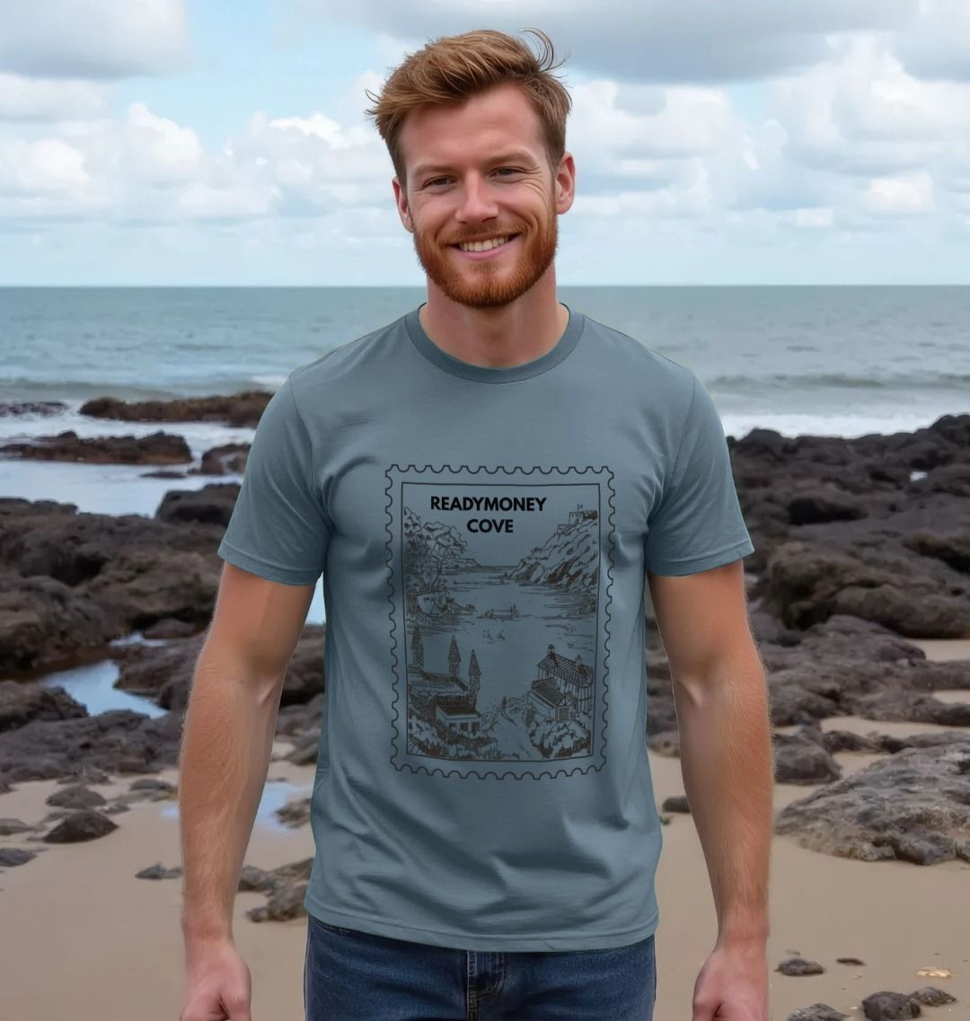 men's t-shirt featuring a unique 'Readymoney Cove' stamp-style coastal graphic print on a stone blue cotton tee
