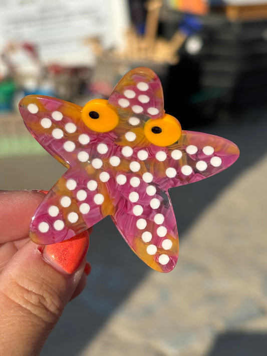 glossy resin starfish hair claw in vibrant pink-orange—fun coastal statement piece with playful beach vibes
