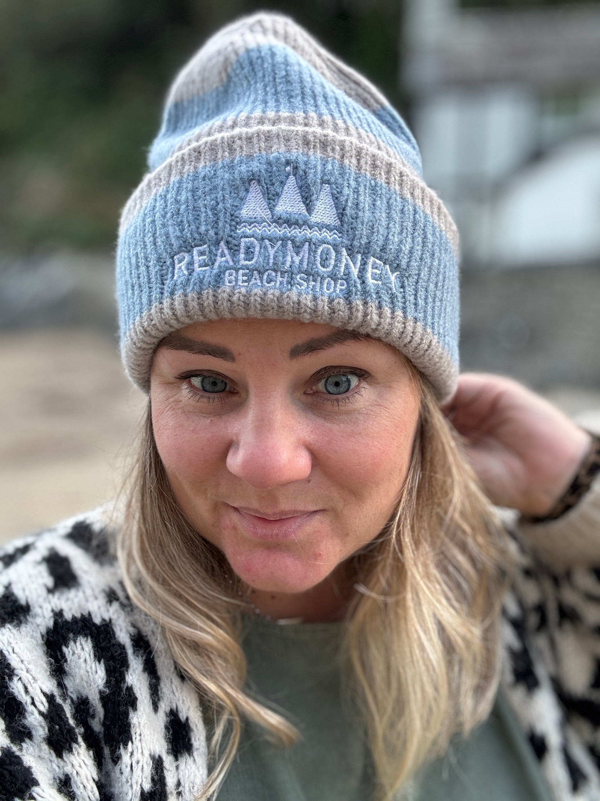 Readymoney Beach Shop beanie in soft blue and beige—cozy coastal knit hat styled for beach walks and chilly outdoor days