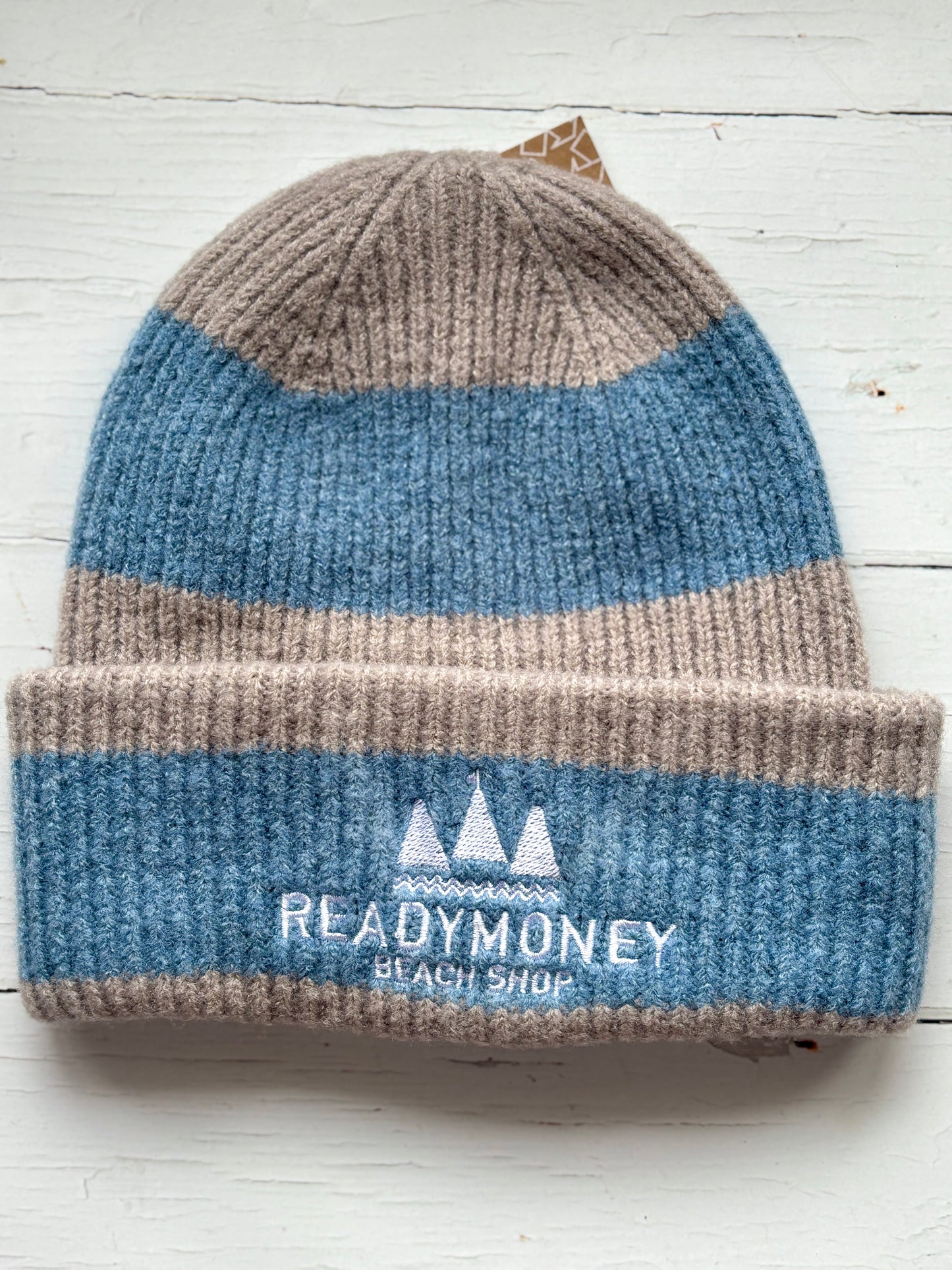 Readymoney Beach Shop beanie in sky blue and stone—ribbed knit hat with coastal embroidery, perfect for cozy seaside style