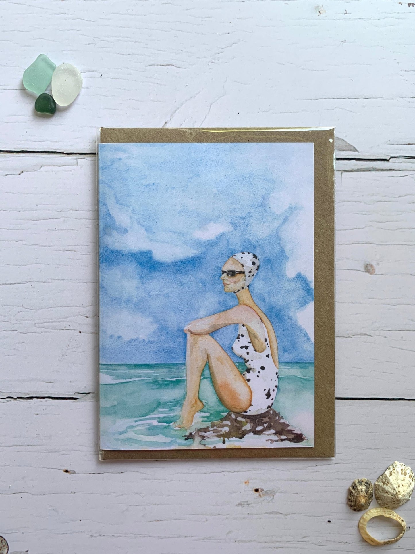 ocean-view watercolor card with spotted swimsuit—artful wild swimmer design for thoughtful coastal gifting