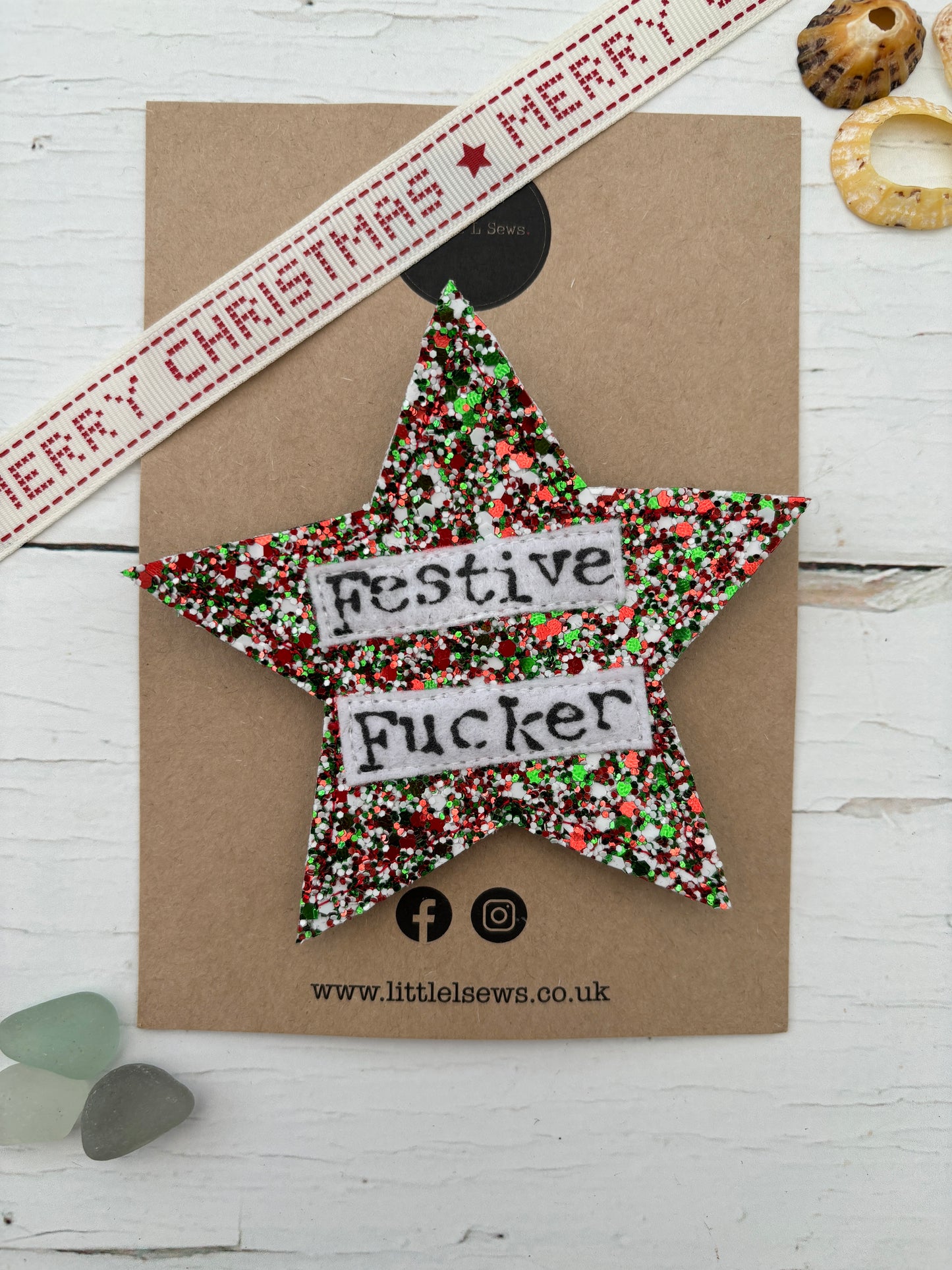 a star shaped mixed glitter badge with the words festive fucker 