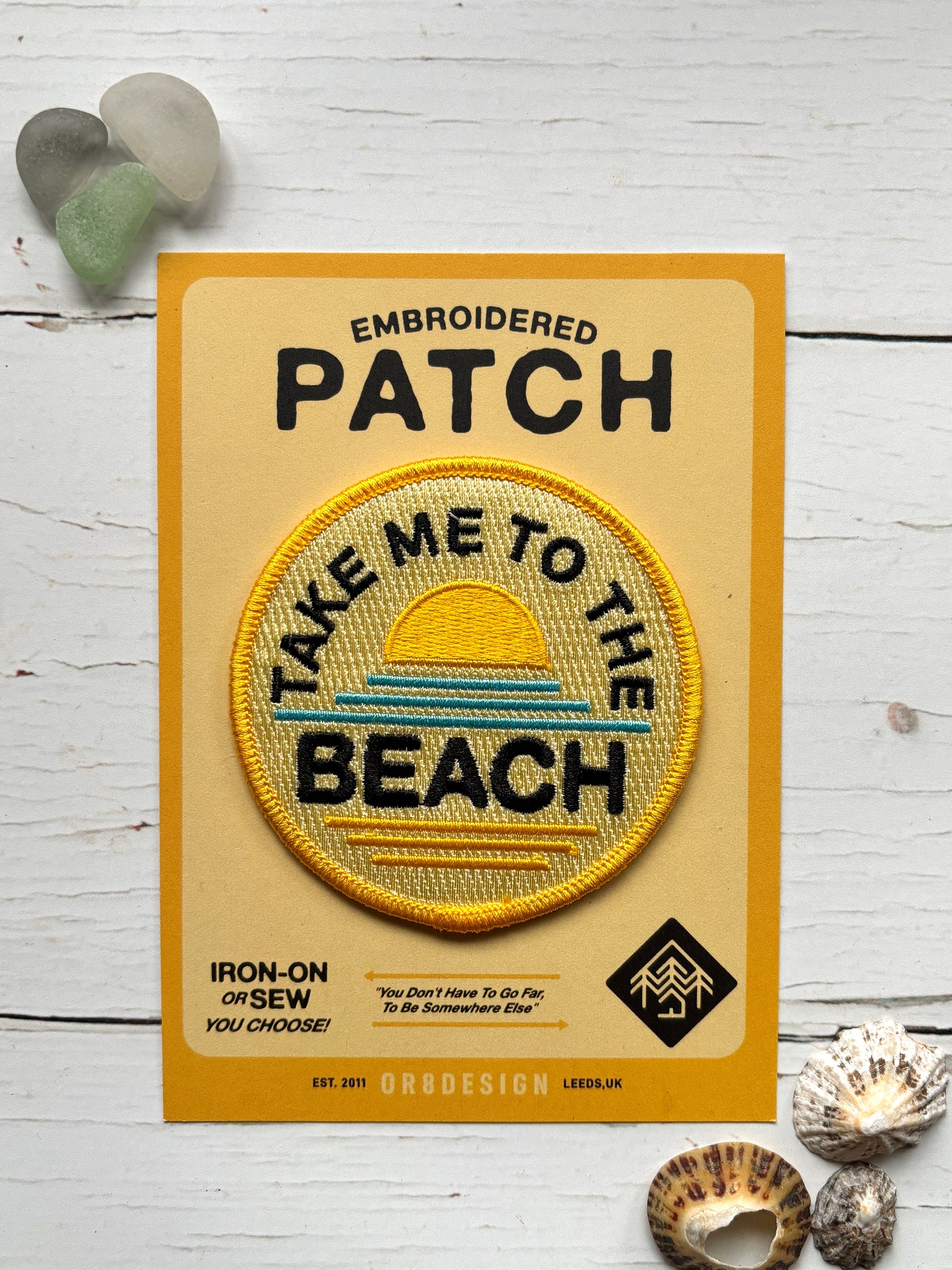 a yellow fabric patch with a sunrise pattern