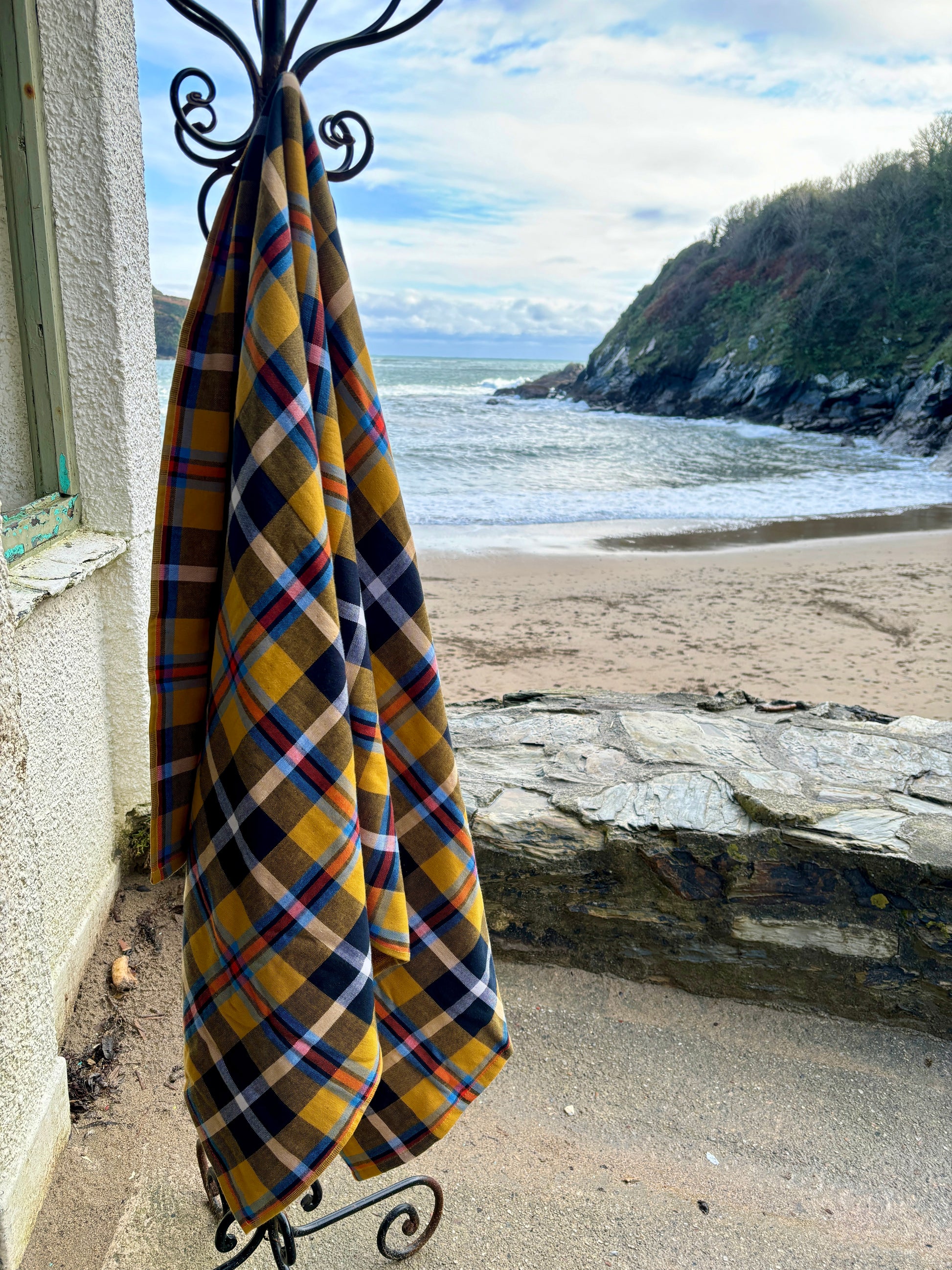 durable, quick-dry yellow tartan cotton beach towel hanging outdoors by the ocean versatile blanket for travel and coastal decor