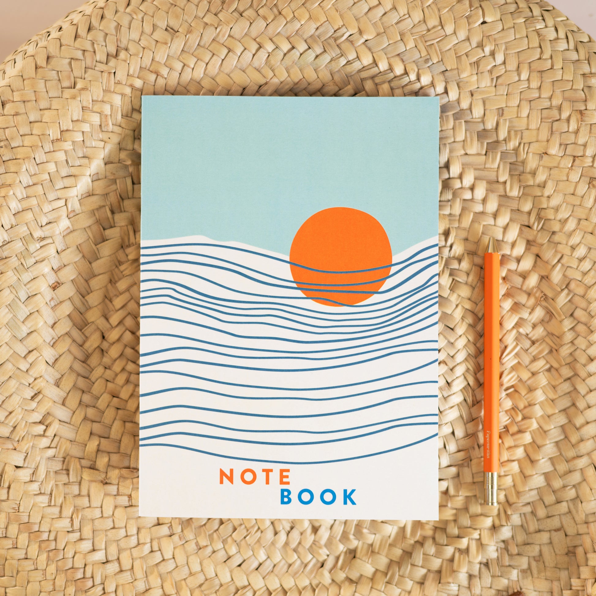 Tidal Waves lined notebook with sunset sea design—coastal journal styled with pen, perfect for mindful writing and gifting