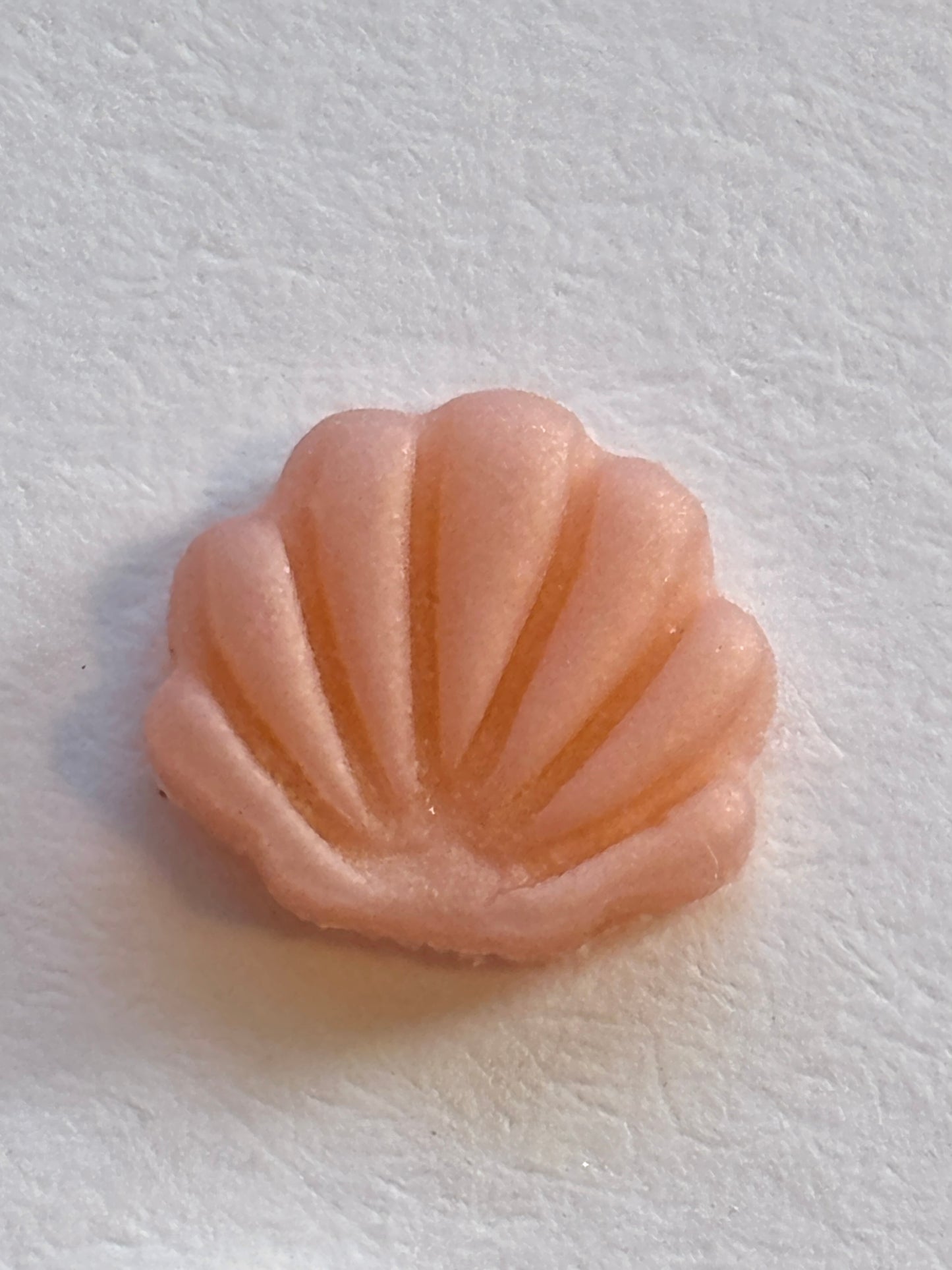 closeup shot of single pastel pink seashell stud handmade tiny polymer clay beach jewelry mermaid aesthetic earring