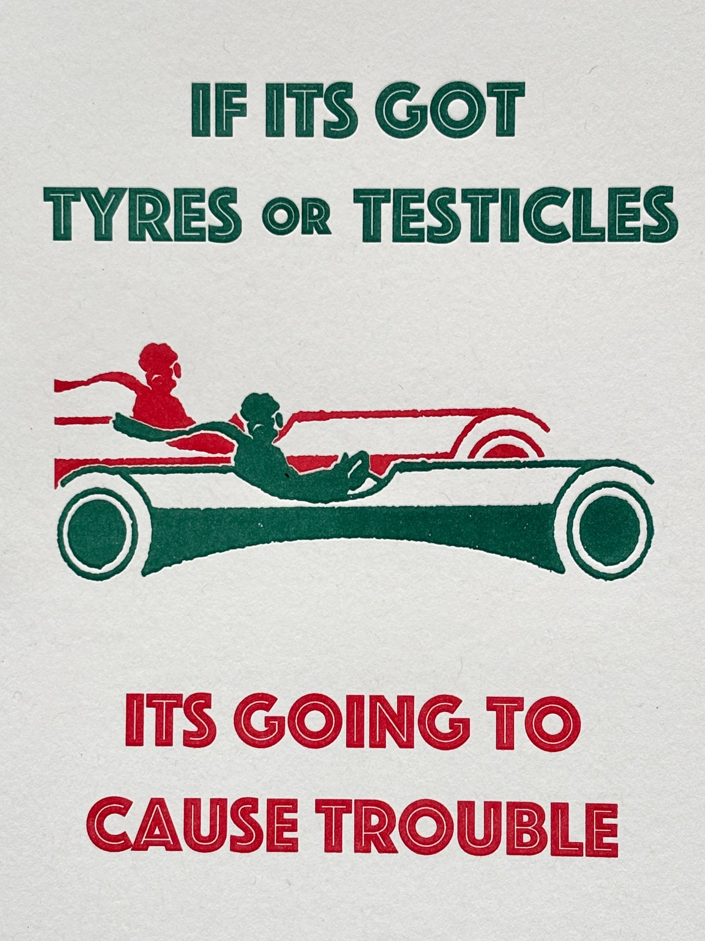 closeup shot of cheeky birthday card with bold red-green quote and vintage car, perfect for humorous gifting and retro card lovers