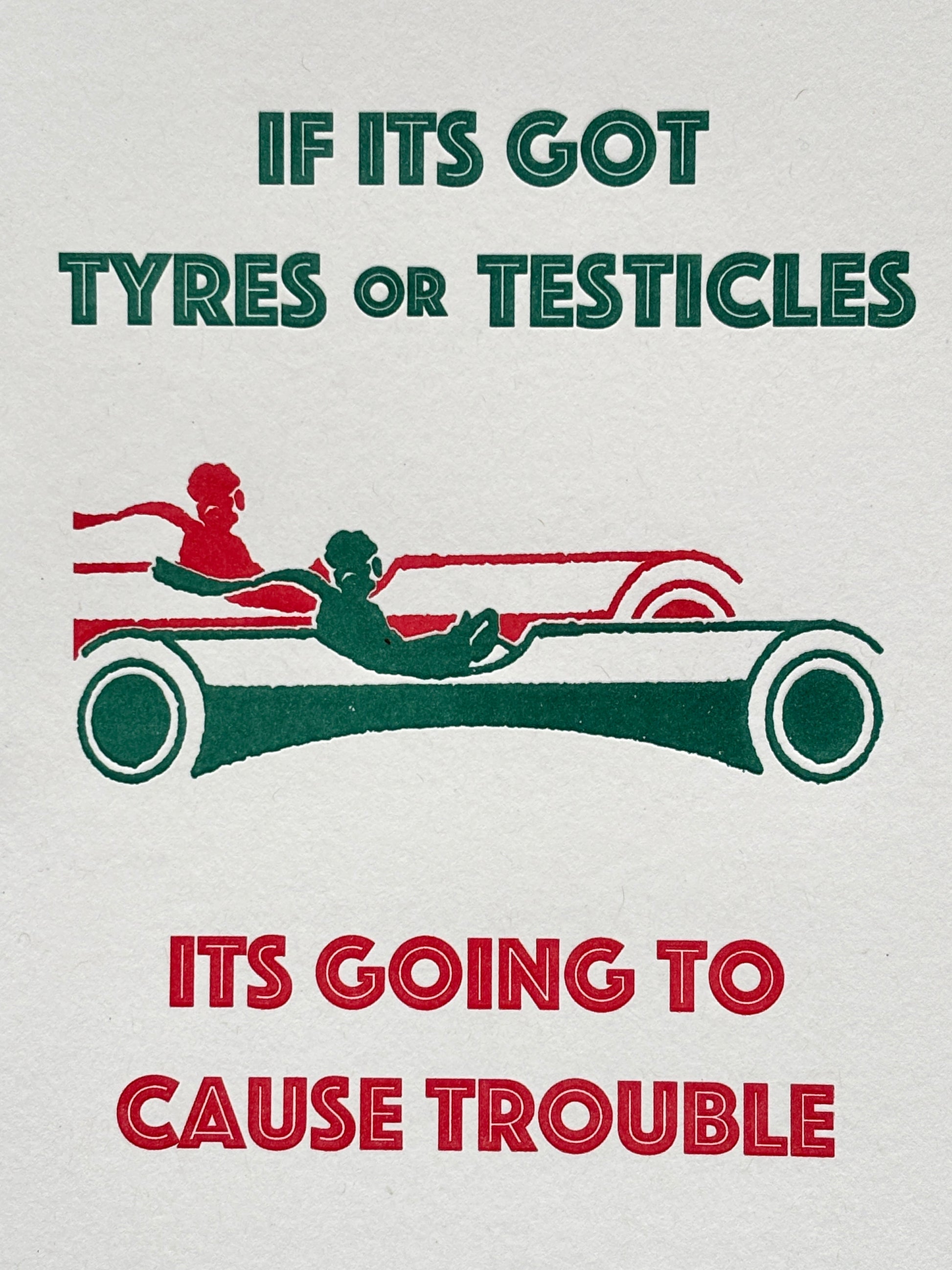 closeup shot of cheeky birthday card with bold red-green quote and vintage car, perfect for humorous gifting and retro card lovers
