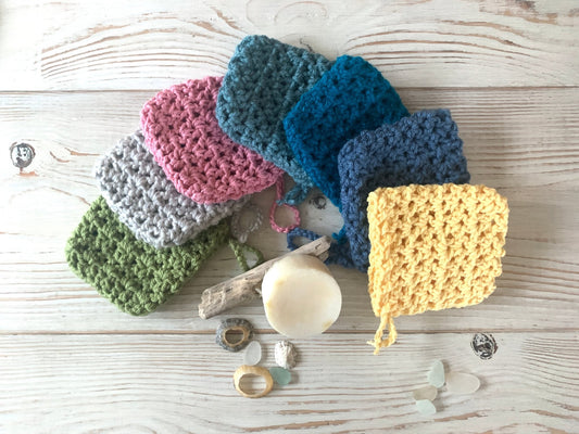 washable crocheted soap saver bags in various colors (pink, blue, yellow) eco-friendly exfoliating washcloth for zero-waste bathing and natural soap