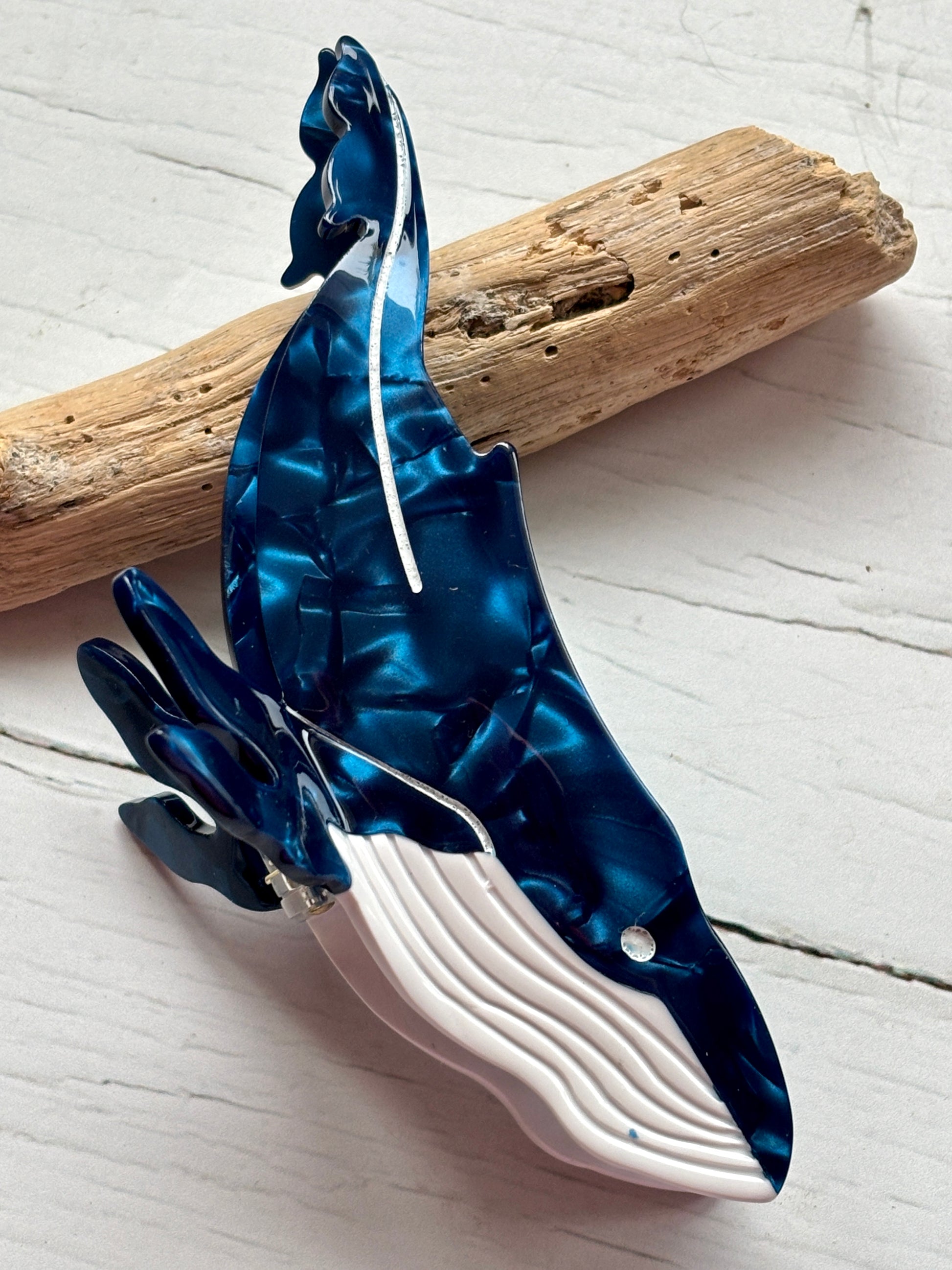 whale hair claw—glossy marbled blue clip with white accents, ocean-inspired shape, and secure grip for coastal styling
