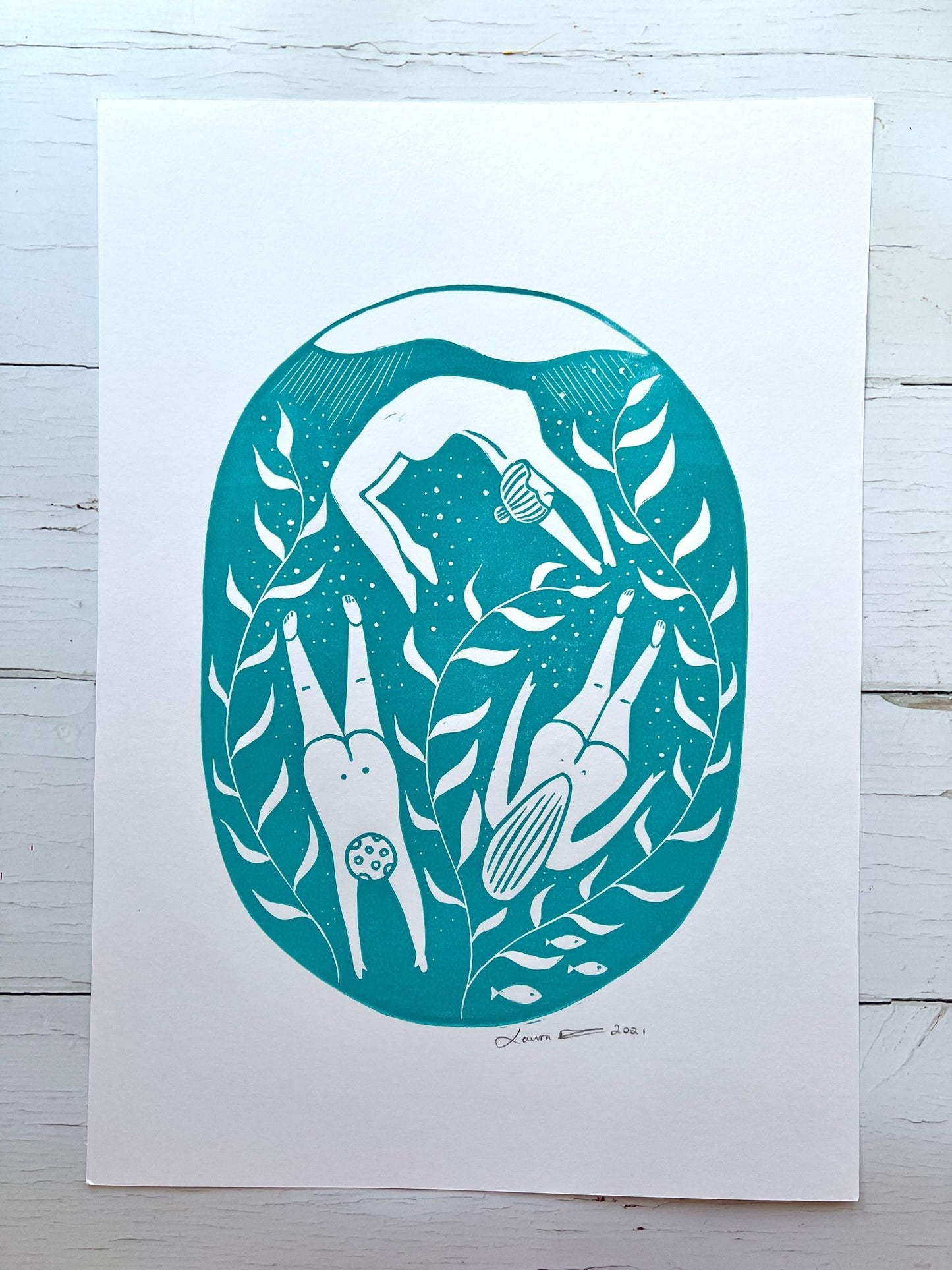 A3 lino print with teal swimmers, sea plants, and fish—stylized underwater art for coastal-inspired decor