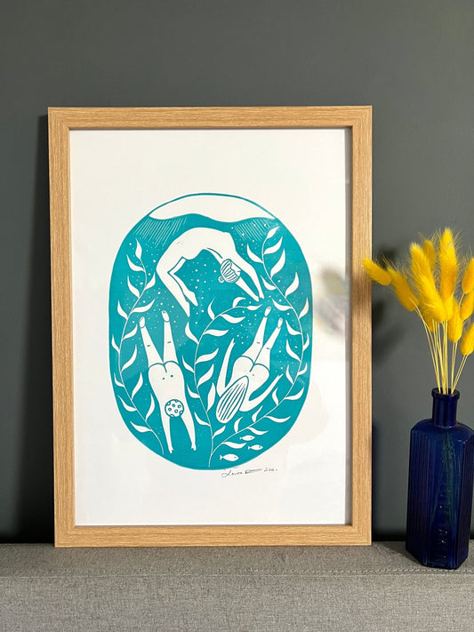 teal A3 lino print featuring abstract swimmers, sea plants, and fish—coastal-inspired modern wall decor