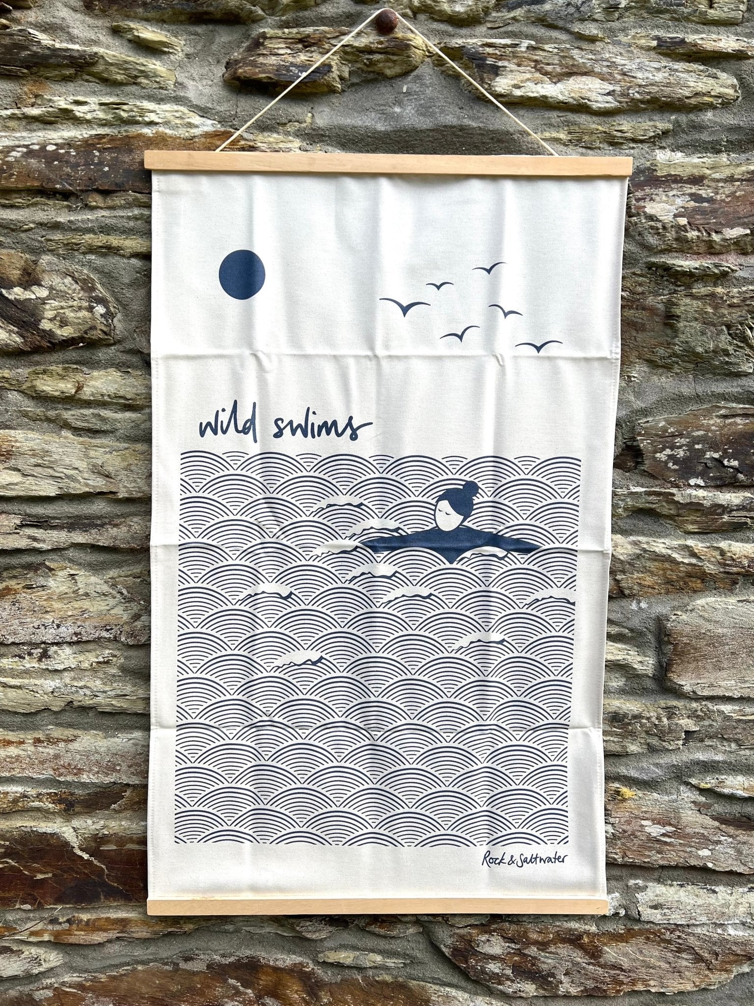 organic cotton tea towel with minimalist wild swimming illustration, ocean wave pattern and coastal design, eco-friendly kitchen textile