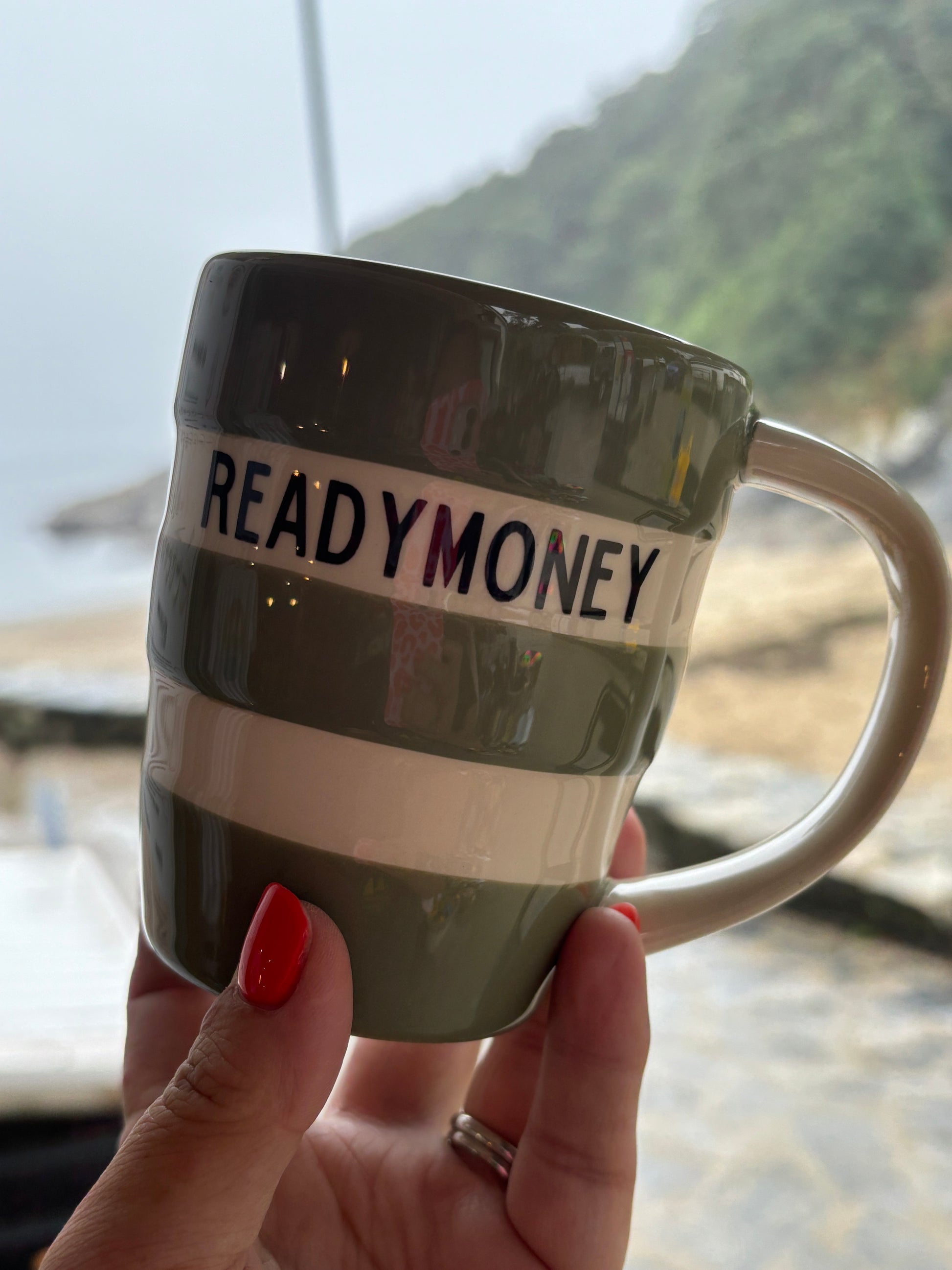 READYMONEY striped green mug seaside lifestyle shot - 12oz ceramic coffee cup coastal beach drinkware gift