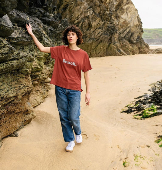 rust oversized women's beach t-shirt with relaxed fit and bold white "Beach" coastal print for casual wear