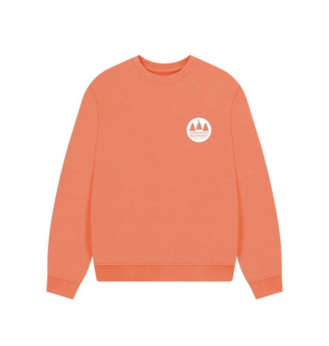 soft apricot oversized women's sweatshirt with minimalist white chest logo—organic cotton, relaxed coastal style