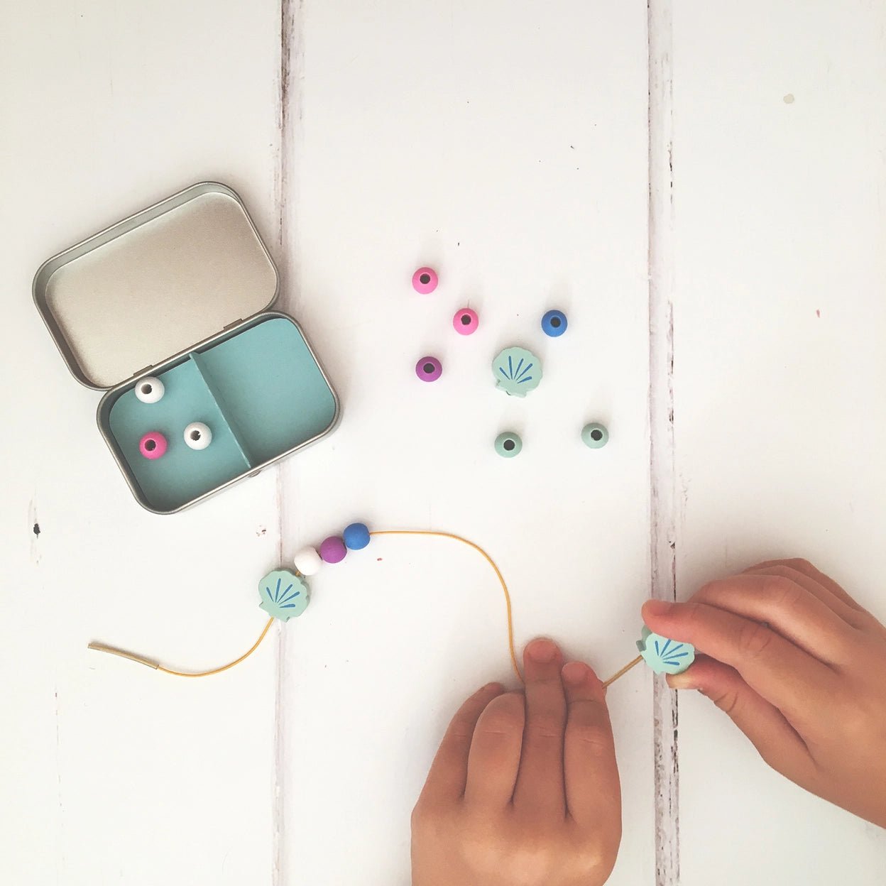 child making mermaid bracelet - DIY wooden bead jewelry craft kit with shell charms & elastic cord in tin box