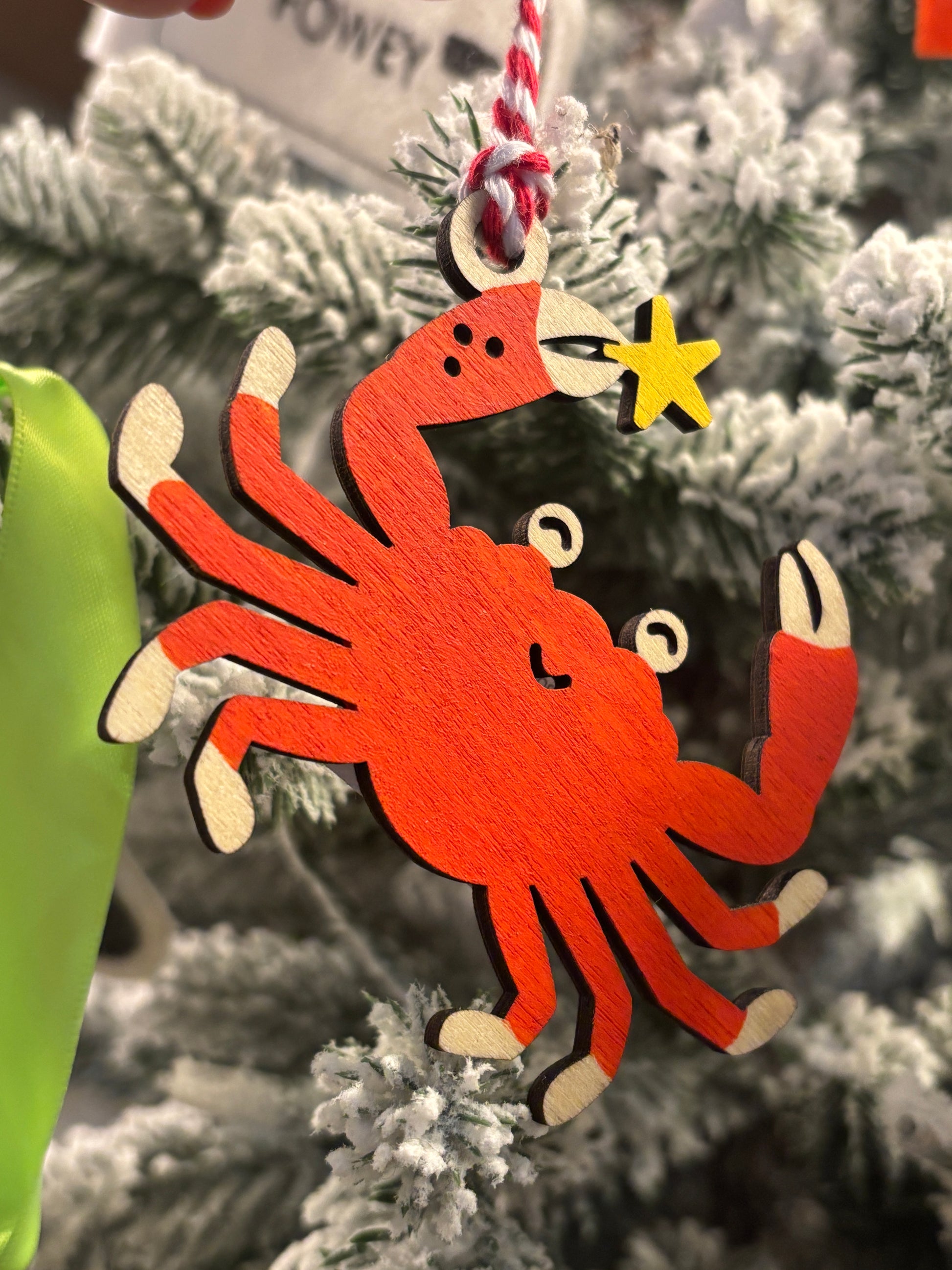 wooden crab Christmas ornament painted orange with yellow starfish, whimsical coastal holiday tree decoration